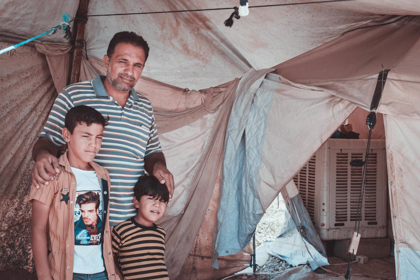 Muhammed in Hamam al-Alil camp
Muhammed Hassan Yunis, 41 years old from Mosul, has been living with his family in Hamam Al-Alil Camp in Mosul for three years. He has six children, the elder child suffers from heart disease and the youngest one has Autism. Both child need special treatment.
The condition in the camp is not suitable for children who need special treatment. In the camps you can only find the very basic daily needs from food and water, limited electricity with no heater or air conditioner, only basic medical treatments.
Muhammed wishes to go back to his home in Mosul city. He misses his house, his job, his neighborhood. He dreams of a stable life with his family in Mosul again.
Muhammed is not able to go back to Mosul, because his house is destroyed, he lost everything he owns, his financial status does not allow him to rent a new house, and he can not even find a job to start over and rebuild his life.
Photo: Helen Baker/NRC
Mosul