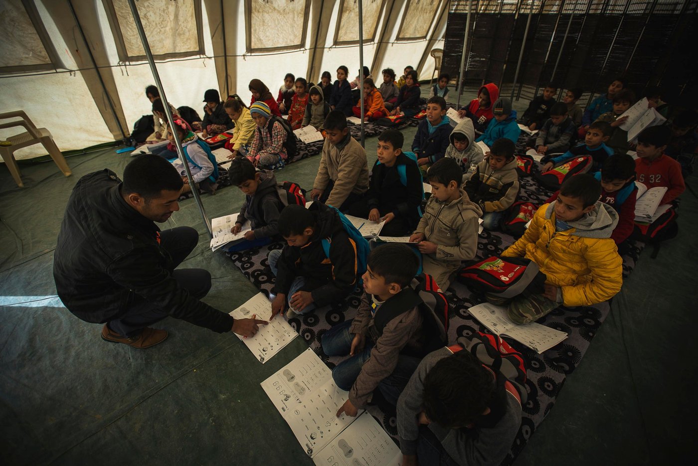 Children who have been recently displaced have missed up to two years of important social and intellectual development. They may have been forced to attend IS schools, or not attended school at all. It's vitally important to return children to a safe, protective environment as soon as possible when they reach emergency sites so that they can receive life saving messages such as hygiene promotion and mine awareness.
NRC provides psychosocial support to help children cope with their new surroundings and any traumatic events they may have experienced. Through our Better Learning Program, we teach children deep breathing and stretching techniques that reduce stress and help improve focus. BLP also uses art as a way for children to process the events they've experienced in a positive manner, which has been proven to reduce things like nightmares and negative behavior in the classroom.
NRC's School Support Center provides a safe space for children to play, learn and grow. Instructors have receive training in how to work with conflict-affected children, and they tailor their games and activities to engage children in their new environment. Children play sports, engage in music and art activities, and also receive basic education classes to help prepare them to go back to school.
Photo: NRC/Hussein Amri
Debaga Camp in Iraq