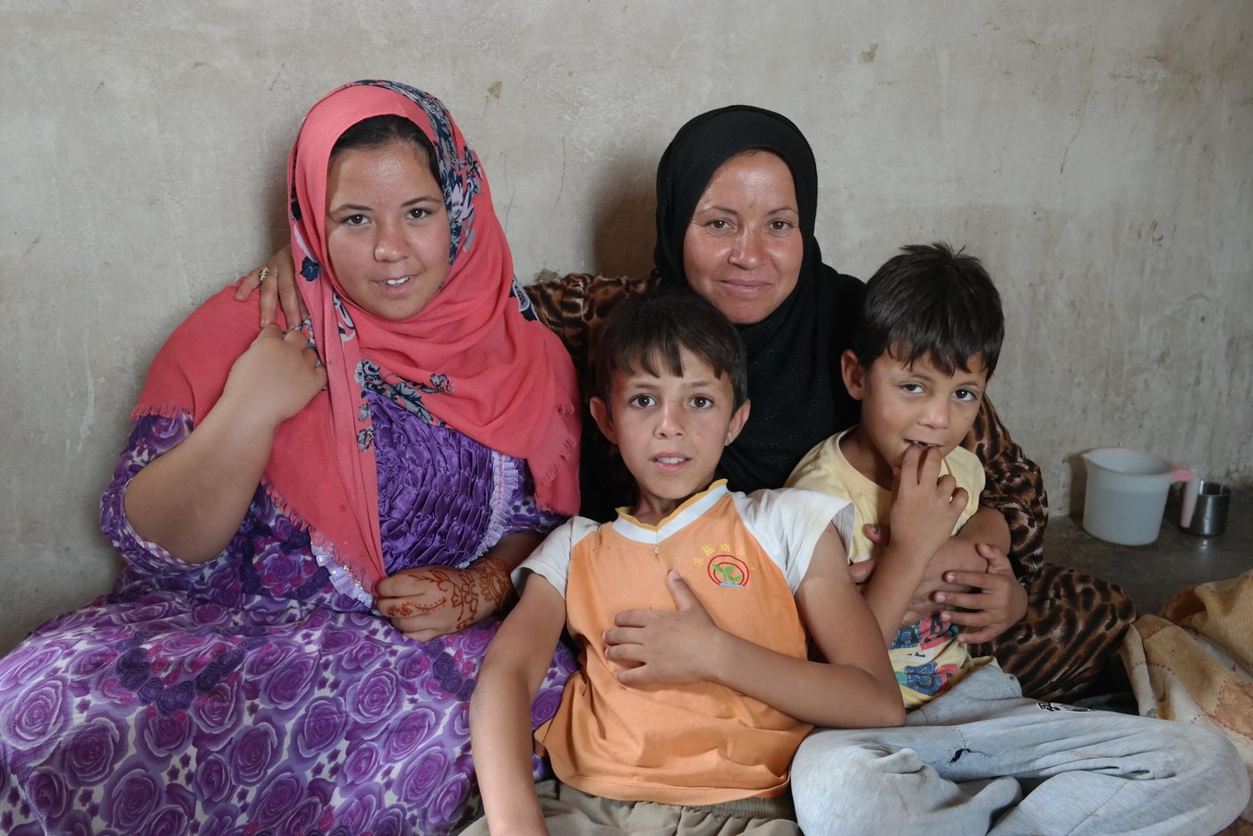 Asmaa with her daughter Isra (16) and her sons Tahir (11) and Bariq (9).
Asmaa (35) lost her husband due to ongoing violence in Iraq and was herself together with 11 other family members injured when they got stuck in the middle of heavy crossfire during the last year’s fighting between ISIS and government security forces in Anbar.
“I don’t know anything about our future, we have no plans, but I hope my children will finish school and have families of their own one day,” she says.
Asmaa managed to escape the fighting together with 23 other family members in July 2014.
“We only had time to bring our identity cards and the clothes we were already dressed in,” Asmaa says.
Today the two women and the rest of the family live in a rented house in Baghdad close to the border which crosses over to their home governorate of Anbar. Although located only minutes away from the frontline where the armed conflict is still ongoing, Sadye and Asmaa have managed to keep the family together and create a new home. With the support from ECHO, NRC has provided them with cash assistance which they have chosen to spend on paying their monthly rent.
“To begin with, we thought we had to beg on the streets, we had nothing. Then we received support from the people living here in addition to the cash assistance,” Asmaa smiles.
Photo: NRC/Becky Bakr Abdulla
