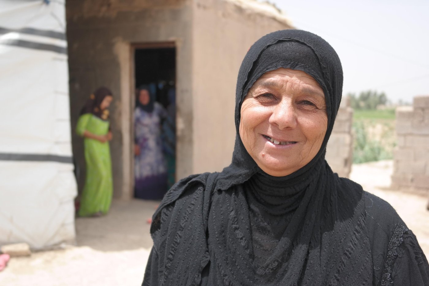 Internally displaced Sadye (55) who is a mother and a grandmother is one of the people who have received much needed cash assistance from NRC. Sadye and her family are originally from the conflict affected Anbar province in Iraq. Like many other civilians in the country, Sadye has suffered huge losses due to the ongoing conflict which has left around 10 million civilians in need of humanitarian assistance.
In addition to losing her home and her livelihood as a former farmer, Sadye lost one of her children to the war in 2008. Her son had sold some of the family’s cattle and was walking home carrying the money from the sale when he was taken by force by members of Al Qaida. He never returned home to his mother, his wife Asmaa or to his four young children.
Today the two women and the rest of the family live in a rented house in Baghdad close to the border which crosses over to their home governorate of Anbar. Although located only minutes away from the frontline where the armed conflict is still ongoing, Sadye and Asmaa have managed to keep the family together and create a new home. With the support from ECHO, NRC has provided them with cash assistance which they have chosen to spend on paying their monthly rent.
Photo: NRC/Becky Bakr Abdulla