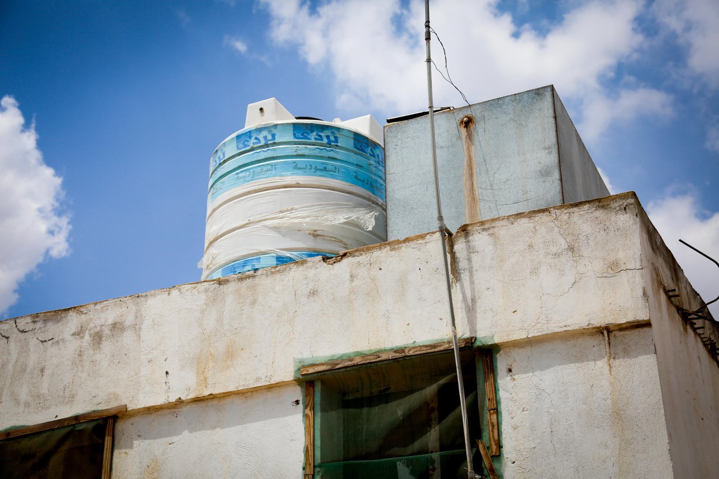 Abu Ayham, 42, and Um Ayham, 40, fled Syria to Jordan five years ago. For the past five years, Abu and Um Ayham have been living in a small brick shack turned home with their four children. Since then, they have endured living disconnected from the municipal electricity network and water services. 

“After the renovation, the situation has improved. We don’t have insects” said Um Ayham. Abu Ayham added “The major thing was fixing the septic tank. Also, the water tank would not fill up completely, we did not have enough water for the family. Now we have two tanks. This is good for the children.” 

In exchange for the renovation provided by NRC, the landlord agreed on giving the family a six months’ period rent-free. Moreover, after the period is over, NRC will continue to support the family with the monthly payment throughout the next year.  

The core of NRC’s shelter program aims to improve the living conditions for vulnerable Jordanians and Syrian refugees living outside of the camps. Rent comprises 50% of household expenses for Syrian refugees and 65% of them do not live in adequate conditions. By upgrading their living conditions and covering housing costs, NRC is creating a win-win situation between landlords and tenants.

Ramtha 
13 June 2019 
Photo by: Pat Rubio Bertran/NRC