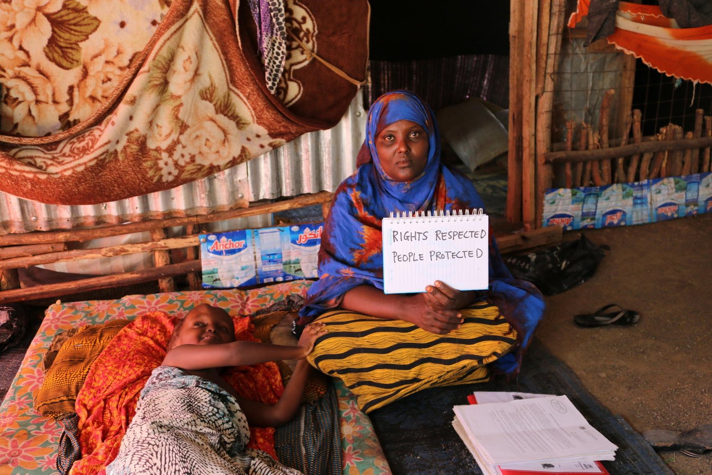 Maryan Dahir muhamed (30) is mother of four children, she relocated to Kakuma refugee camp in May 2013. She used to live in Dagahaley section of Dadaab refugee camp (2009 - 2013).
Maryan's son Zakaria has a complex medical called known as hydrocephalus. He has a swollen head resulting from fluid accumulation. He has has undergone 6 head surgeries at the Kijabe Mission Hospital in Kenya. These have done little to cure his condition. A catheter has been implanted inside his head to help drain the fluid into his lower body to ease the head pressure. This condition started to develop one week after Zakaria was born. He has feeding problems. While he needs a special diet that helps to remedy his condition, this cannot be derived from the WFP food ration system (maize, oil, salt, beans and cereals). In addition, as per the doctor's prescription he needs to consume a large amount of milk to provide the necessary nutrients to fight the hydrocephalus condition. His mother, Maryan, cannot afford 2,500 Kenyan Shillings that is needed to buy a 5-litre can of preserved milk.
Maryan's application for US resettlement was rejected by the US Immigration Centre (CIS). She was not informed why her request was not granted. She had hoped to find a way to the US where her sone can receive better medical treatment.
She has a message for American President Donald Trump: 'Show that you care about the suffering of people. We are humans like you'. Photo: NRC/Nashon Tado