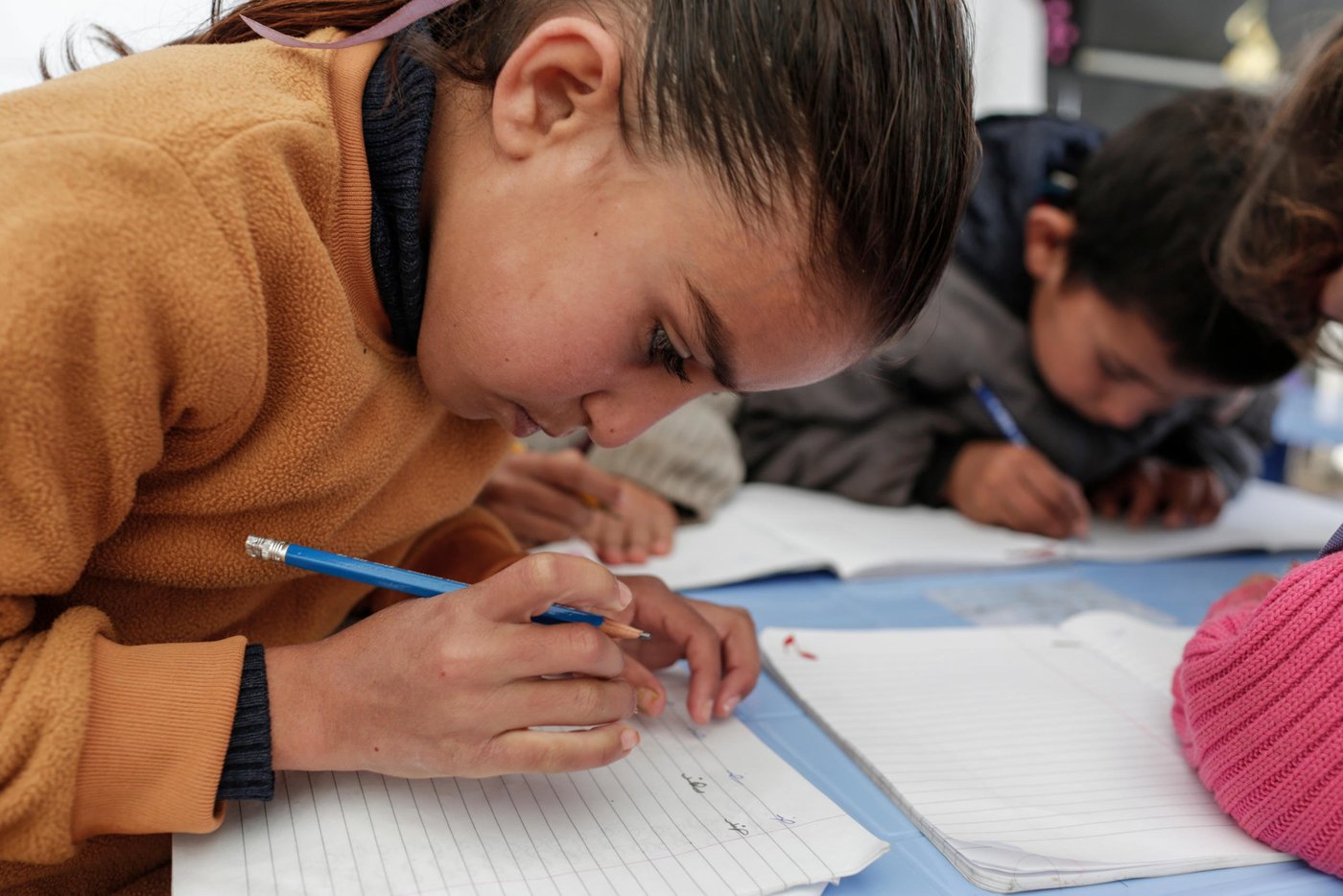 Khadijah, 9, attends classes at an informal tented settlement for Syrian refugees in the Bekaa Valley, Lebanon.

As Storm Zina raged across Lebanon, hundreds of vulnerable Syrian refugee families, particularly in the Bekaa Valley, have been badly affected as temperatures fell well below zero and more than 25cms of snow fell. NRC staff distributed wood and plastic sheeting to allow refugees to reinforce their tents in order to prevent them from leaking and from collapsing under the weight of snow. Floor raising kits were also distributed to lift the base of tents away from the frozen ground and to protect against flooding when the snow melts. Drainage kits and sand bags were distributed as well to allow refugees to protect tents and latrines from flooding once the thaw begins. NRC has also delivered clean drinking water where water supplies were frozen and, where meltwater is filling up septic tanks, NRC is ensuring they are emptied safely.

Photo taken on Wednesday January 14.

NRC/Sam Tarling