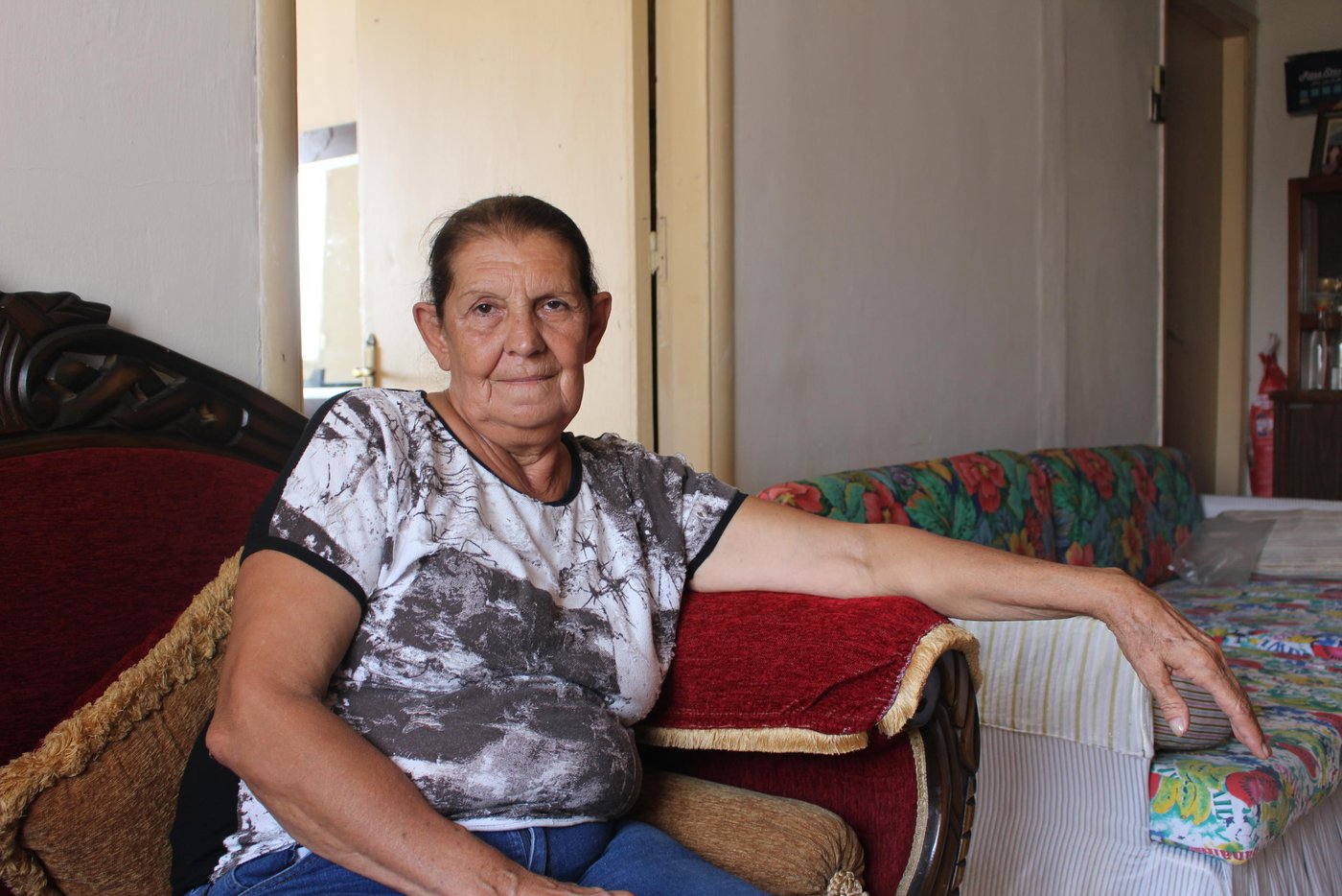 Hayat, 70, is one of thousands of people who were affected by the blast that damaged parts of their homes. She and her two sons with their families live in Karantina, XX km away from the explosion site. They live on different floors in the same three store-building. At the time of the explosion, she was sitting outside on terrace of the building’s rooftop. 

“I was sitting on our terrace when the first explosion happened. I thought that airplanes were bombing,” says Hayat. “I immediately ran inside to get some of my key documents and my purse when the second explosion happened. It was so loud and it blew me off the ground.” 

“I didn’t know what to do and my first thought was that my sons could not have survived this. Then, I saw my son, Giofar, coming up the stairs calling for me in panic to check if I was okay. The blood was dripping from his head and his body was full of glass shatter,” says Hayat. 

“We have lived in this building for 27 years. I have witnessed all the wars and conflicts in Beirut but never have I seen Beirut so severely damaged as this,” says Hayat. “The scene outside our home looked like a battle field, beyond what you can comprehend. People were running around in panic, bodies on the ground, blood everywhere, buildings falling apart, cars under the rubble and glass shatter all over,” she says.  

“There is a hospital opposite to where we live but it was totally destroyed and we were not able to move to take my son to the hospital. We lost him in the turmoil but a police officer had seen him injured and took him on his Vespa to a hospital about 15 km from where we live,” Hayat explains. “He came back fully stitched but we are lucky he survived,” she says. 

“My other son’s wife was giving birth a few hours before the explosion, she delivered a baby boy. The hospital had to release her after just a few hours just to make space to other people who were heavily injured in the blast,” says Hayat. 

“My grandchildren are all traumatized. They are afraid and can’t sleep during the night. Whenever they hear any loud sound they start screaming and fear another explosion will go off. We are constantly worried that something else will happen,” she says.

“We have a lot of needs now, the windows, curtains, and furniture are all damaged. The glass shatters destroyed everything and the walls have fallen down. My kitchen is not functioning and the water pipes are all broken. We need our homes to be repaired urgently but we can’t afford the repairs,” Hayat says. “We don’t know when we will get assistance but we need everyone’s help to rebuild the streets of Beirut,” she says.  

“When I look at the destruction around us, I can only say we were saved by a miracle,” says Hayat. “In the end all the material damage can be replaced, we can eventually buy new ones but a life can’t be replaced,” she says. 

“Imagine, one of the neighbours in the building next to ours is Syrian. He has been living alone for a while and his family in Syria. A few weeks ago, the situation where his wife and two daughters live in Syria worsened so he brought them here to be in safety and escape the war. But they didn’t escape death, the roof fell over them in the explosion and his wife and two daughters died. If you see him now, it’s like he has gone mad,” she says. 

“My husband died when my children were very young and I raised them as a single mother. I put all my heart and effort to raise them and keep them safe. My biggest fear is to lose them now when they are adults. They are my whole life and if something happens to them I wouldn’t be able to handle it. The situation in country has become unbearable. Our hearts are broken, the people are tired and Lebanon has suffered enough,” Hayat concludes. 

Photo: Racha El Daoi/NRC