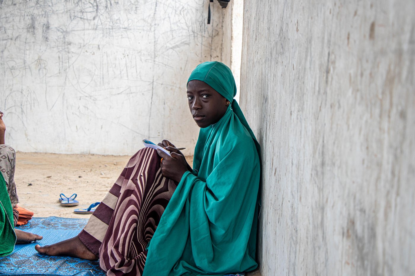 Facebook: " I have never attended school, but my mother enrolled me in nonformal education classes offered by NRC. I want to learn a lot so I can help people in future with my knowledge," says 15-year-old Hafsat.
Meimuna, who is Hafsat’s mum, noticed the passion for learning in her daughter. “She took classes to learn how to read Arabic, but I saw the importance of education. I want her to grow up and be an important person in life”
To support children who have been adversely affected by conflict in Northeast Nigeria, NRC creates access to quality education by setting up temporary learning centres in displacement camps to engage children in basic literacy and maths skills. NRC’s education programs also help children to transition to formal schools to continue learning.