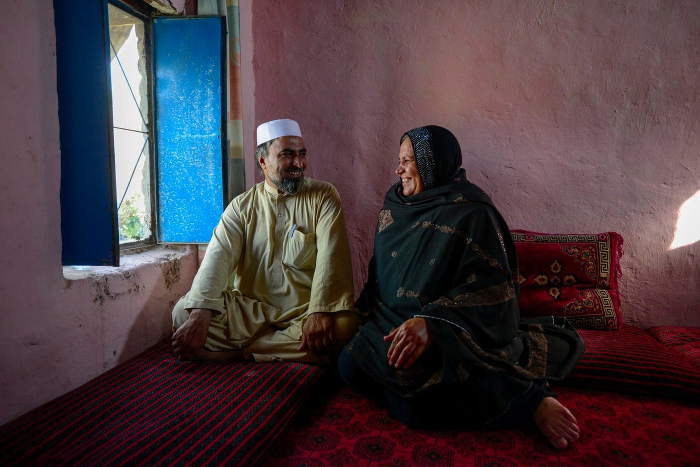 The 2015 winner of UNHCR's Nansen Refugee Award, Ms Aqeela Asifi, with her husband Sher Muhammad in Kot Chandana refugee village in Mianwali, Pakistan. Ms Asifi, an Afghan refugee, has dedicated herself to breaking down cultural barriers in order to educate refugee children, particularly for girls. Sher Muhammad has never wavered in his support of her work for over twenty years. To date more than one thousand students have completed their studies with Ms Asifi. Ms Asifi has been recognized for her decades-long effort to promote education in this conservative community, where many have been reluctant to send their children to school. Currently there are more than fourteen thousand refugees living in Kot Chandana refugee village, where more than fifty percent of school-aged children do not receive an education. Photo: UNHCR/Sebastian Rich