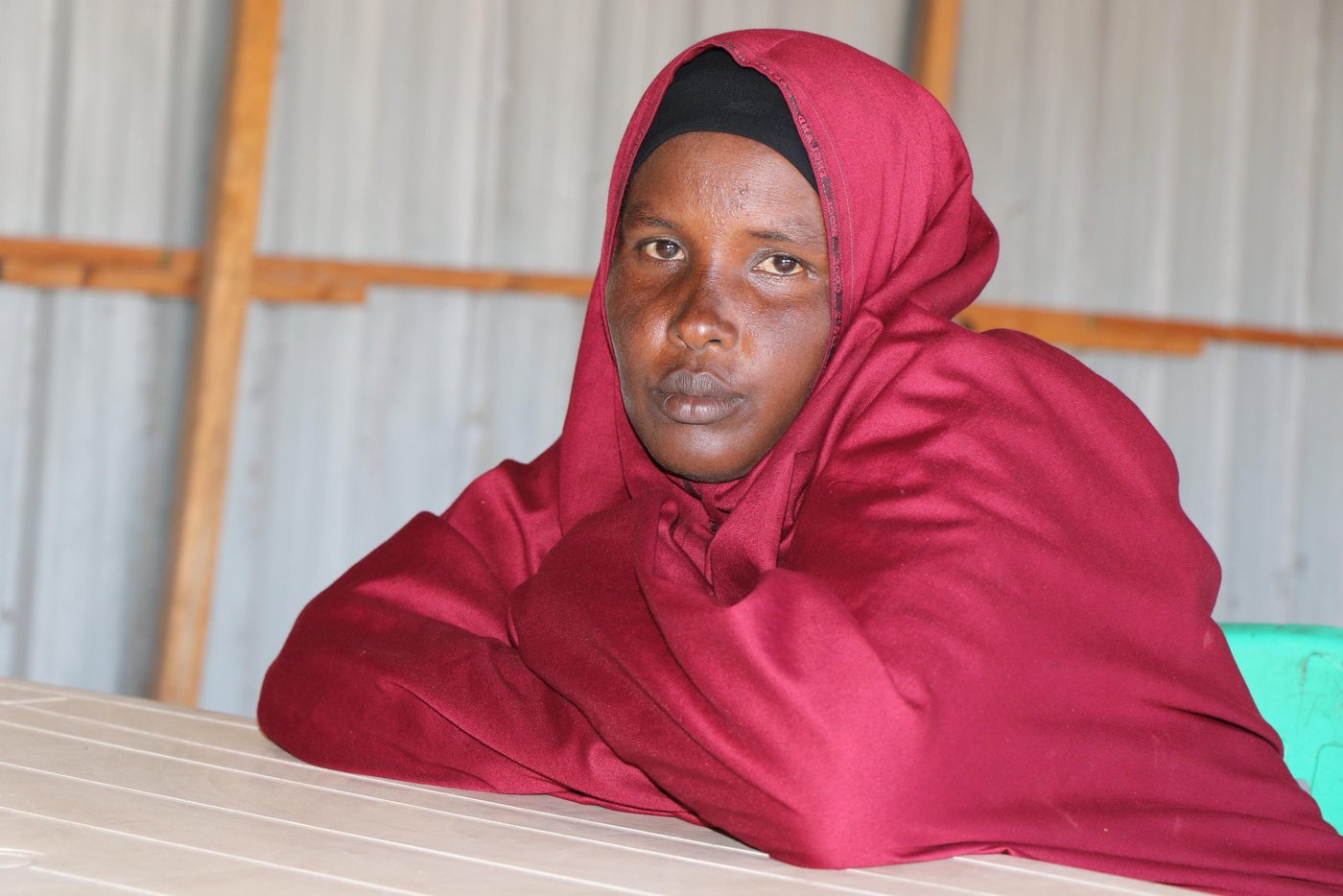 Khadija Ahmed Ali, 48, did not know where to find legal services. Now, NRC’s legal aid clinic in her IDP settlement has transformed her life and those of many other IDPs as they can now easily access justice without any challenges or obstacles.

Khadija lives with her family – 9 children (4 boys and 5 girls) in Jabuti IDP camp under Galbeed centre in Kismayo town, Lower Juba region. Khadija and her family was displaced from the 2016 drought that severely devastated all their livelihood assets and they have been living in Jabuti IDP camp for the past five years.

"Before NRC’s legal aid centre there was no specific place or any sort of guidance for the IDP communities where they can receive legal services. In the IDP camps, communal conflicts, disputes and Sexual Gender Based Violence (SGBV) cases are very common and happen at any time, but getting legal assistance was very difficult. These negative practices have become accepted by the IDPs because you do not know what to do and where to seek a remedy,” says Khadija. 

“Sometimes, it is difficult to publicly share your problems, and the reason is that there is lack of understanding about the legal system including law and order actors such as the police station, and also the right place to report your case – these are the major challenges we have had before,” she adds. 

There are enormous social, and cultural barriers in reporting SGBV cases within the IDP camps, compared to other cases. Survivors are often reluctant to pursue cases due to social stigma. NRC provides legal aid to individuals or groups who are unable to effectively claim and exercise their rights. Displaced populations may be in need of legal assistance but either they do not know how to access these services, or lack the capacity to utilise them. Legal assistance is therefore essential to promote and increase access to justice.  And yet, access to justice is a basic principle of the rule of law. If justice is absent, vulnerable individuals like Khadija are unable to have their voice heard, exercise their rights, challenge discrimination and hold decision makers accountable.  
A new dawn! The legal aid clinic.
In 2020, NRC set up a legal aid clinic in Jabuti IDP camp within Galbeed centre in Kismayo town. The clinic was part of several durable solutions activities being implemented under the Danwadaag durable solutions programme. It has ensured that displacement affected communities are provided with specialised counselling and legal assistance related to several cases including but not limited to civil documentation and housing, land and property. The presence of the legal aid clinic has made a huge difference to Khadija and the other vulnerable communities in Jabuti IDP camp. They now have increased access to legal services, including collaborative dispute resolution structures and mechanisms. The legal aid clinic has ensured the delivery of justice to DACs in Jabuti IDP camp is impartial and non-discriminatory.  The clinic has therefore been a key strategy in enhancing access to justice for vulnerable displacement affected communities who continue to face several obstacles within the Justice Law and Order Sector in Somalia.

“I’m one of the people who have benefited from legal aid. I had an unresolved assault case and I wanted to report it, and then I came to this clinic. I was received by NRC staff, I was interviewed and provided with guidance on the availability of free legal services. At first, I had reported my case to the dispute resolution committee. I wanted to have my case resolved but we were unable to reach a final decision. I think they tried their best but they were unable to resolve the matter. After several failed attempts to close the case, it was referred to the police station, who also referred us to the district court. However, when I heard about this new legal aid clinic, I reported the matter to the NRC staff at the clinic and Alhamdulillah, following several meetings and a mediation, my case was finally resolved and I can say I got justice.” Khadija Ahmed

About Danwadaag Durable Solutions Programme

The Danwadaag (meaning common purpose) Durable Solutions Consortium is a three-and-a-half-year programme supported by Foreign Commonwealth Development Office (FCDO). It aims to enhance progress towards durable solutions and (re) integration for displacement affected communities (DAC) in targeted urban centres in Banadir, South West State, and Jubaland.  The programme is delivered through a consortium approach led by the International Organisation of Migration as the lead implementing agency, Concern Worldwide and NRC as implementing partners and the Regional Durable Solutions Secretariat (ReDSS) as the learning and knowledge partner. 

Photo: Abdulkadir/NRC.