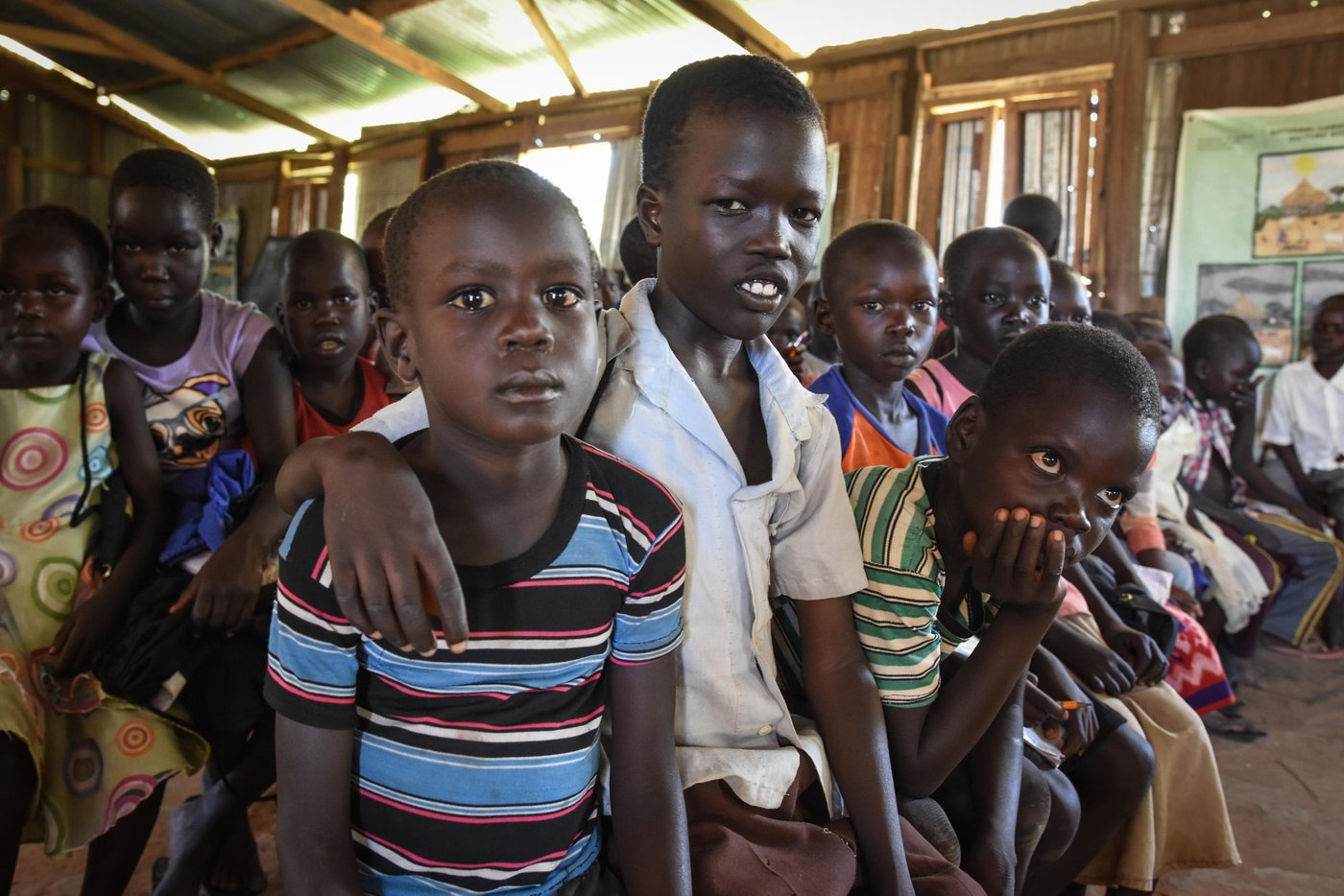 Levi Hakim (in white shirt) has fled from Mukaya and found protection in Yei, where he is attending NRC's Education in Emergencies classes.
"At the time we fled there were a lot of gunshots and we started to run. I was scared. We heard a lot of gunshots. The only thing we could bring was something for cooking and a jerry can. The mattresses and our other belongings were burned. Our house was set on fire.
At the time we ran they had already set the house on fire.
The whole family fled together."
They were two sisters, six brothers, him and his parents.
"We were using a bike. My father was bringing me and a young sister by bike. We fled in the morning and reached here by 3 pm."
"The situation here is okay. School cleans my mind and makes me think that I can be a good person in the future. That is why I want to go to school.
In the future I want to repair vehicles. That is what I want to learn. To repair and to drive.
I am hoping for peace. If there is peace, people will live freely. If there is stability we will go back. If peace is there."
The photo is from St. Thomas primary school in Yei, South Sudan. The school is providing education for children displaced by conflict - who have come to Yei for safety. NRC has built a new school building and latrines, and is running the education program with support from ECHO.
Photo: NRC/Tiril Skarstein