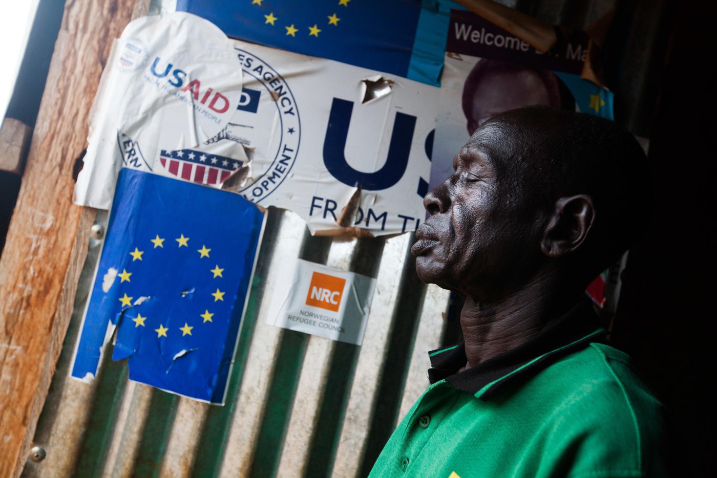 30 November 2016. Juba: Gatluak Kang, originally from Maiwut, Upper Nile state, walks at the school, where he works as a security guard, at the UN Protection of Civilians (PoC) site in Juba, South Sudan.
Gatluak, who has 4 wives and 7 children, lives alone in the displaced camp in Juba since 3 years ago, while his family is refuged in Gambella, Ethiopia.
The conflict officially broke out on December 15, 2013, between forces loyal to President Salva Kiir and those loyal to former Vice President Riek Machar. Since then, an estimated 1.6 million people has been displaced inside the new country's borders. In addition, more than 640,000 people have fled to neighbouring countries. Hunger is on the rise.
According to OCHA, more than 6.1 million South Sudanese are in need of protection and humanitarian assistance such as food, clean water, education and other basic services.
Gatluak Kang’s story:
Gatluak used to be a wealthy farmer, with some lands to cultivate and four wives in his hometown, in Maiwut. He was also a soldier when South Sudan reached the independence in 2011, but right after the civil war broke out in December 2013, he sent his wives and seven children to a refugee camp in Gambella, Ethiopia, and he sought protection at the Juba PoC. Since then, he lives totally alone and tries to spend the time working voluntarily as a security guard in one of the schools of the camp. “It’s my only way to support the community at my age,” Gatluak admits. His shelter is right next to the school and he patrols the facility all night to make sure nobody breaks in to steal the few furniture.
Gatluak is optimistic about the future of South Sudan. “I’m sure we’ll reach our freedom and peace soon or late,” he explains. That’s why he claims the international community to help to find a political solution. “I really need to join my family before I die,” he adds.
After observing the school activities everyday, he admits “the teachers are doing a huge work, sacrificing themselves to educate the new generations.” But he is concerned it’s not enough. “There is not food for the students,” Gatluak says.
Christmas doesn’t mean much for Gatluak. “All the humanitarian workers are going for holidays to their own countries and stay with the family, but what about us?” he asks. “The PoC is going to have the same needs and problems before, during and after Christmas,” he concludes.
--------
Photo by Albert Gonzalez Farran - NRC