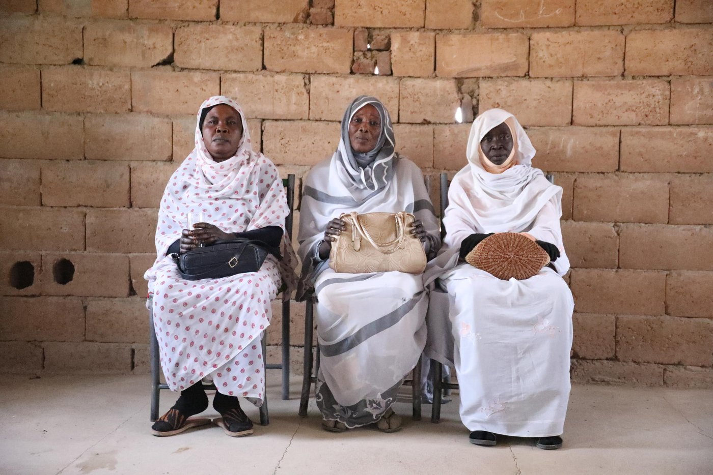 With the help of the European Union, NRC is helping schools in areas affected by displacement in White Nile. Under the Better Learning Program, NRC has provided 108 PTA members and 140 teachers with training for improving schools, better hygiene practices, and providing emotional support for the children.  

The training introduced PTAs of different areas in White Nile with methods and plans to improve schools and provide a better learning experience. We also trained teachers on turning schools into a safe sanctuary for the children to raise morale and motivation. 

“NRC gave us very useful training. They helped us realize we’re dealing with children from diverse backgrounds. Some of our students came here to flee the war in South Sudan or even in the west,” said Manal. 

“Some even live in dire circumstances and have to work after school to support their families. We now try to find ways to make school less stressful and more amusing for them,” she added. 

The PTA of Al Hila Al Jadeeda consists of 20 members of parents and teachers. The women in the community are highly active in the betterment of their conditions. Fifteen members of the association are women, and only five are men. This active role comes with its price. 

“We have had to face many obstacles in our community while doing this work. People are saying we’re negligent of our children and home duties,” says Aziz, Parents Teachers Association member and mother of a student in Juwairya School. 

Aziza tearfully adds, “The training from NRC gave us huge motivation. It made everything we do worth the struggle. The training helped us plan and motivated us to start construction early.” 

After receiving the training organized by NRC, the PTA was motivated to start this year’s construction ahead of receiving funds. And despite the heat and the other obligations they have, men and women of the community volunteered, like every year, and started stacking bricks and plastering to build classrooms. 

“I find motivation in the commitment the other women show for this work. Our children are proud of us and are happy for how far their school has come,” Aziza said 

 Photo Credit: Rawan Kara/ NRC