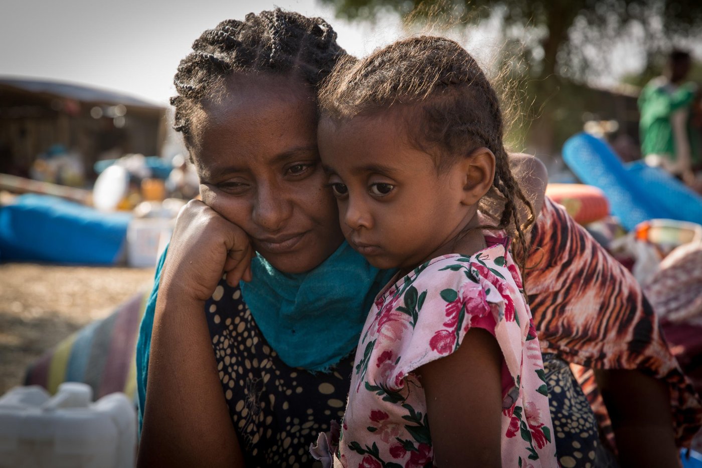 Leilti (30) and her daughter Lela (3) are tired after their first night sleeping under the open in Um Rakuba camp. They arrived with the rest of the family of five the day before and are waiting together with a big group of new arrivals close to the entry of the camp. Leilti is five months pregnant, and found the journey to Sudan very hard.

"I wish I don't have to give birth to my baby in this place, " she tells NRC. 

Photo: Ingebjørg Kårstad/NRC