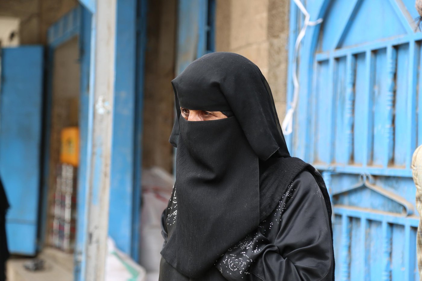 Juma’a Saleh, 40, is a mother of eight orphans. She is seen here receiving WFP food aid from NRC in Amanat Al Asimah’s Azzal district follwing two months of suspension.
“I have very few resources and lack an income so I was forced to stop my children’s studies as I could not prioritise their education amid these bad conditions,” Juma’a said. “To get enough food, pay the rent and buy required medicines are the priorities for the family nowadays.”
Juma’a suffers from diabetes and needs medicines to treat her condition. One of her daughters also suffers from a bladder and kidney disease and she needs $50 per month to pay for these medicines which she can barely afford.
“Sometimes generous people help me with the costs for medicines but most of the time it is difficult to find the money from anywhere, so one of my daughters has resorted to working as a cleaner in a school to help us pay the rent. NRC has played an important role in assisting my family over the last few years by providing us with food on a monthly basis.
“Getting enough food was not a problem over the last few years as we received food aid, and any other income we managed to raise we used to cover other basic needs like medicines and water.”
With funding from the World Food Programme, NRC has been supporting people in the capital Sana’a with monthly food baskets consisting of flour, beans, cooking oil, sugar and salt.
In June 2019, disagreement between WFP and the authorities over the necessary conditions needed for the delivery of food aid led to WFP temporarily suspending food distributions in Sana’a. NRC was forced to stop its WFP funded distributions. Following a welcome agreement reached by WFP and the authorities NRC resumed food distributions in the capital.
"During the last two months our suffering was aggravated and many times I did not find food for my children,” Juma’a added. “I borrowed money from my neighbors but could not pay it back until now.”
“We had to prioritise buying food over spending money on medicines, so my daughter could not have medicine for her bladder and kidney condition.”
Juma’a said: “It was Eid day for us when our neighbours told us food distributions would resume. I felt happy to be receiving food baskets again.”
Photo taken on 2 September 2019
Photo: Nasser Abdulkareem/NRC