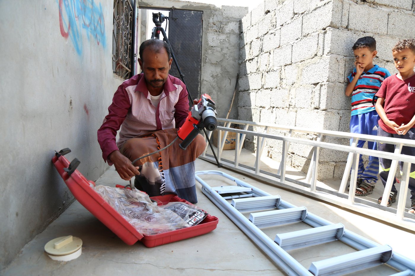 Adel Ali became an electrician in 2014, just before the war in Yemen broke out. The violent conflict decimated job opportunities nationwide, but Adel has been lucky. His skills have stayed in demand, because of the need to rebuild and repair so many damaged buildings.
There was just one problem. “Electricians need a drill, ladders and other equipment,” he explained. But Adel could not afford these tools. “I lost many opportunities for work as a result.”
Then, last year, Adel got the chance he needed. As one of 155 people selected for a special project by the Norwegian Refugee Council (NRC) in his village, he was given training to develop a business plan and budget, and a small grant to make it a reality.
Adel knew exactly what he would spend his grant on: the right tools for his job.
“Now I can work easily and I have attracted more customers,” Adel says. Even during Covid-19, he has managed to keep growing his little business, to the point that he is now taking on more staff. When we spoke to him this month, he shared the good news: “I’m training up some promising electricians who are working with me now. I believe in self-employment and I encourage others to build their own skills that allow them to depend on themselves.”
And one day, it is a business he hopes to pass on to his own family. “I hope that my children became electricians like me, because it is a good job.”
This project was funded by the French Ministry for Foreign Affairs, as part of our efforts to provide more sustainable and long-term solutions to the humanitarian crisis in Yemen. NRC also provides frontline emergency support to families in immediate need of live-saving assistance.
Photo: Nasser Abdulkareem/NRC