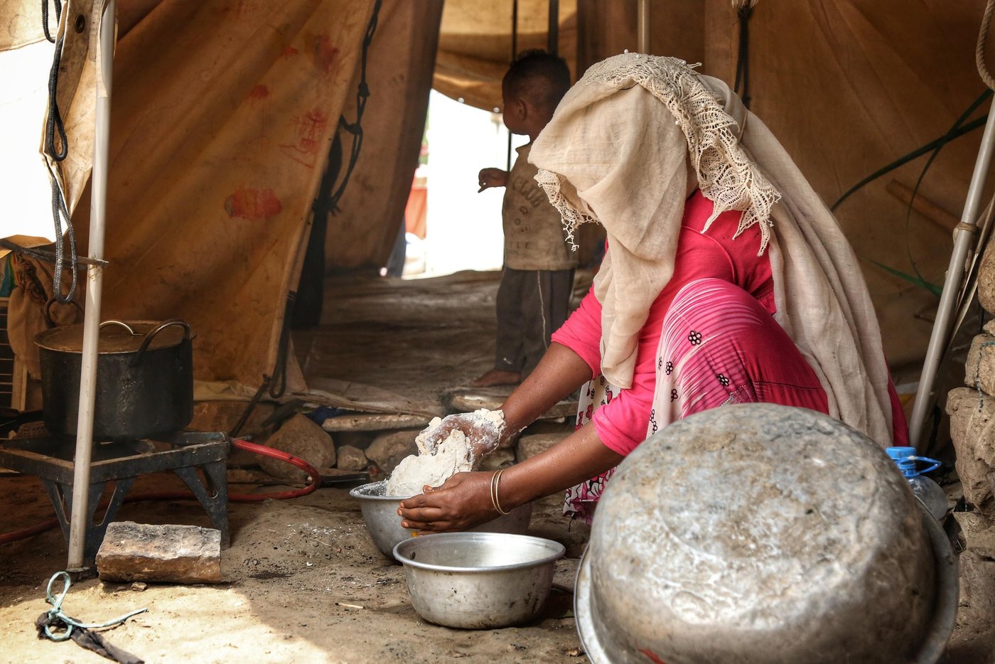 Ahmed's wife prepares the lunch for the family inside her tent in Al-Malika camp in Taiz.
Photo: Khalid Al-Banna/NRC