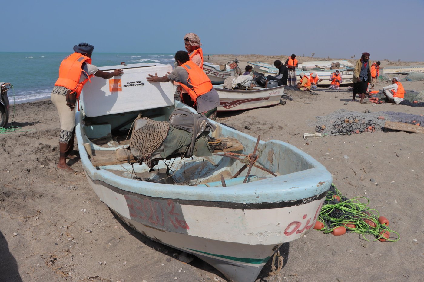 Zaid, Abdo and their friend loading the icebox to the boat

To help the coastal communities in At-Tuhayta stay on the water, the Norwegian Refugee Council [NRC] and the Yemen Humanitarian Fund provided fishermen in his area with a package of useful support. Everyone received life jackets and other equipment, and training on best fishing practices and how to navigate and stay safe at sea. They also received a small cash payment to help them through the tough times.

Photo: Mahmoud Al-Filastini