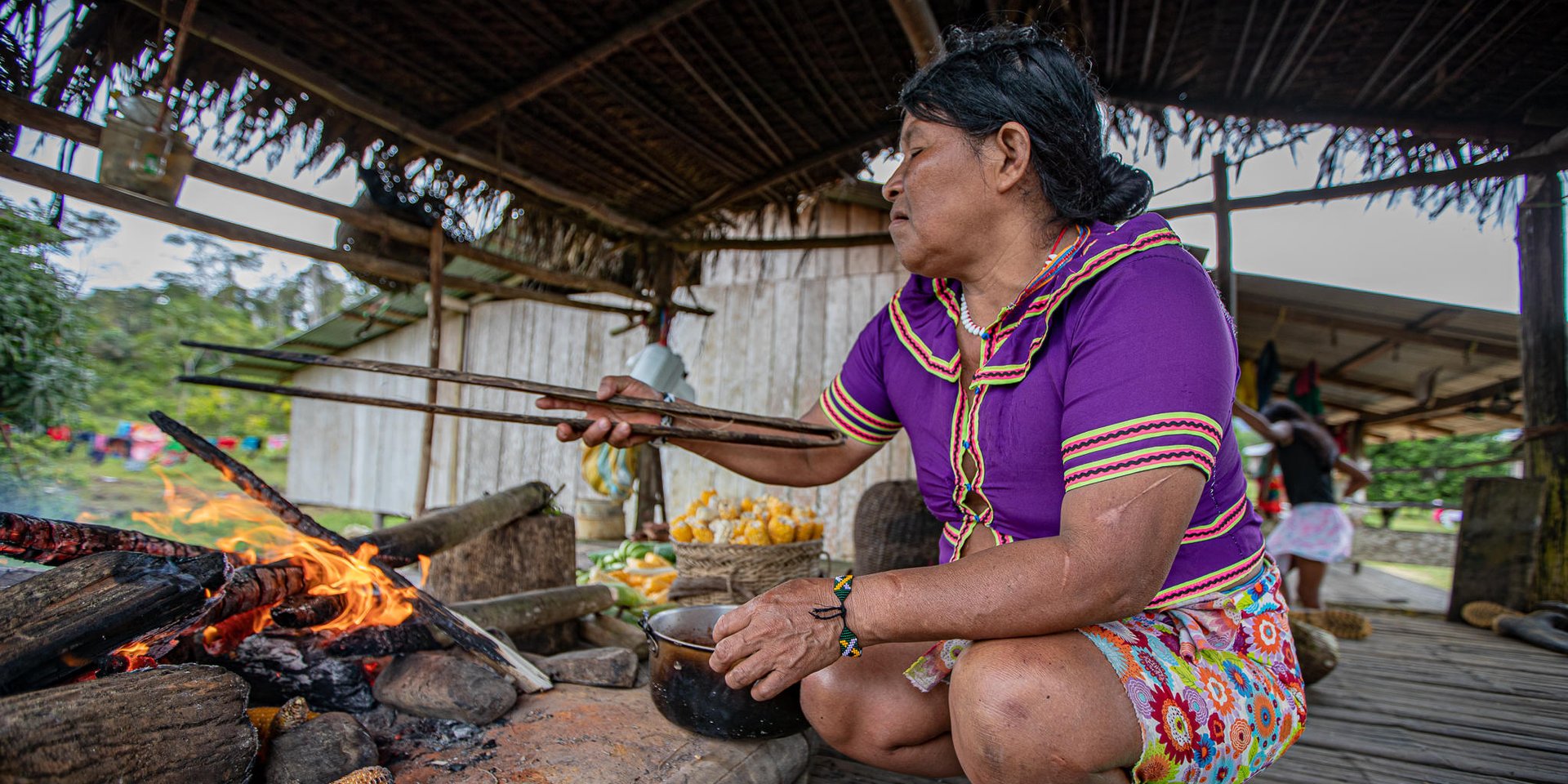 Woman cooking on an open fire.