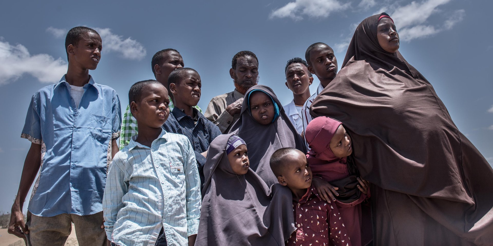 Today, Halima (32) (right) and her husband Abdinajir (50) (middle back row) are returning to Mogadishu with their big family of ten children. They have been living in Kenya’s Somali refugee camp for the past 6 years, after fleeing Somalia’s capital in 2010. 

“We are happy about our time in Kenya. But all our friends in Dadaab camp have left and gone back,” said Halima. “It’s a sign to us that it is time to leave.”

The UN refugee agency is helping the family return by plane to Somalia. NRC is providing information to refugees who decide to return, about conditions on the ground.

Mogadishu is still fragile and it will take time to re-establish for Halima’s family to set up a life there. But Halima is hopeful: “Yesterday in the camp I had nothing. Now I have a small aid package to help us return. I will make a life for myself and my family in Mogadishu. I am a confident woman and strong mother.”

Halima is pregnant with their 11th child. We wish her and the family the best of luck with their new lives.

Halima is one of about 23,000 refugees who have left Dadaab camp this year to return back to Somalia. They are part of a return programme set up by the UN’s refugee agency and the Government of Kenya. NRC is working to ensure that people returning to Somalia are given information about the areas they are going to, and that process is well coordinated and returnees are protected. 
 
….

For Facebook:
Today we met Halima on the dusty airstrip of Kenya’s Dadaab refugee camp. She and her husband Abdinajir were returning to Somalia with their 10 children, after six years living as refugees. They flew with 40 other families who are going home to build new lives in Mogadishu. Halima is expecting her 11th child soon. We wish her good luck!

Date: September 2016

Photo credit: NRC/ Fredrik Lerneryd