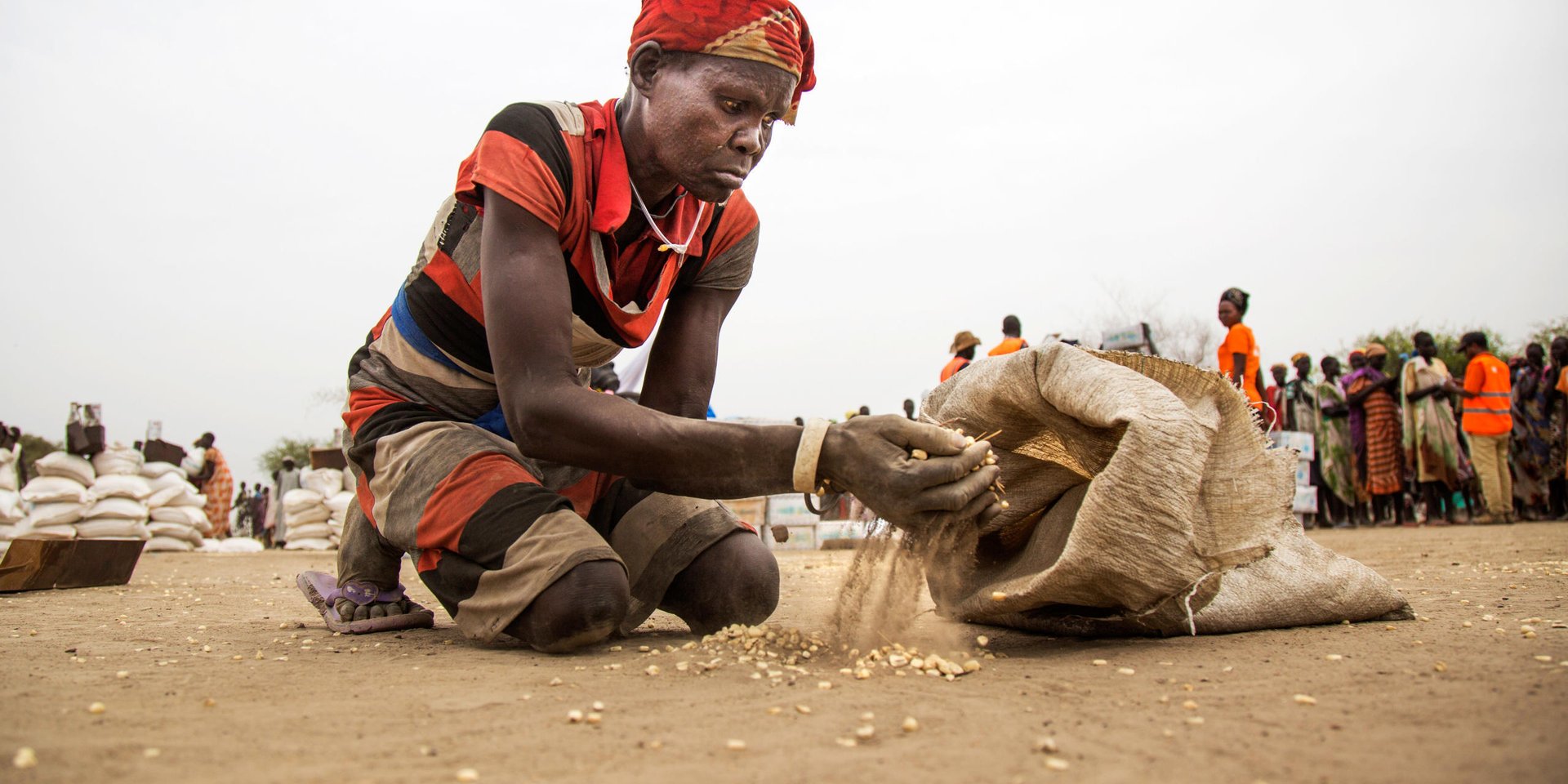 9 March 2017. Ngop: Mary Nyariakalok, from Nyadiet, collects remains of white maize during a food distribution in Ngop, Unity state, South Sudan. 

Mary lives in Nyadiet (two hours away fron Ngop) and takes care of six children back home. “All these grains I’m now collecting, after I clean them and cook them, will give food to my family for one day at least”, she assumes. 

In Nyadiet, Mary doesn’t have many chances. “I normally sit at home and wait for something to come,” she admits, “there is no food and I don’t know how to manage.” 

The Norwegian Refugee Council (NRC) distributed food (maize, lentils, oil and corn soya blend) for more than 7,100 people in Ngop. The food distribution is part of a Rapid Response Mission coordinated and funded by the World Food Programme (WFP).
Photo by Albert Gonzalez Farran - NRC