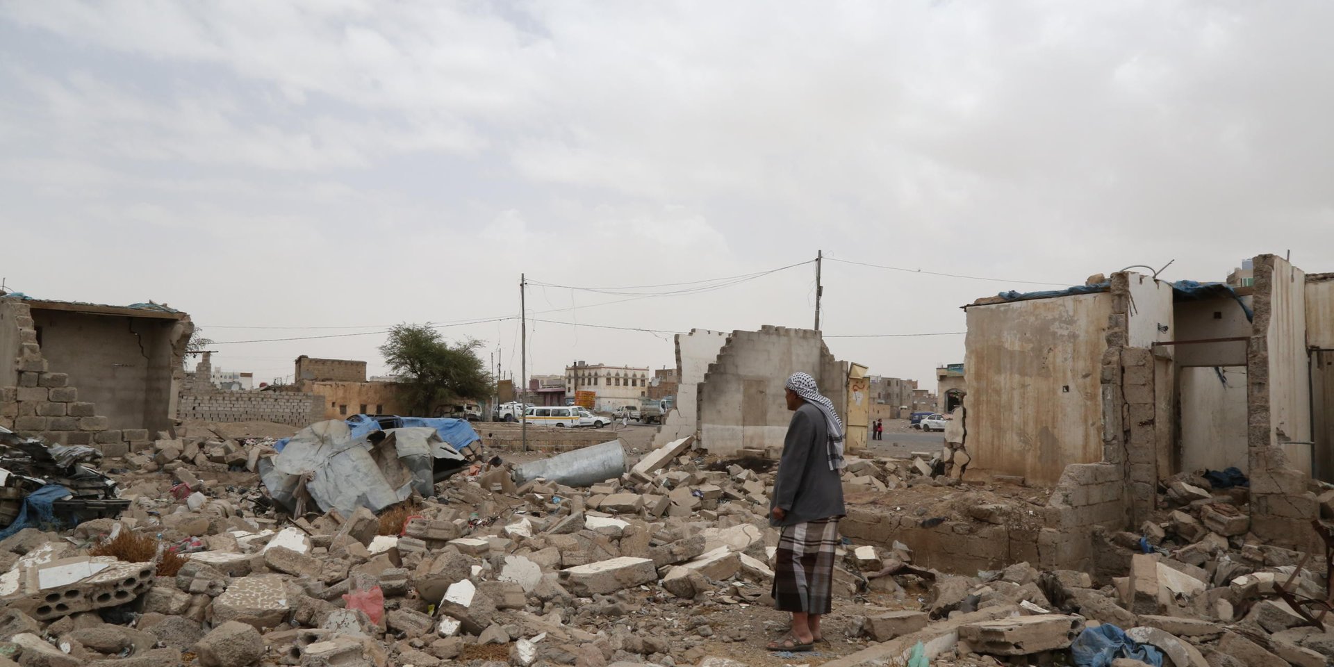 Yasser al Hibshi, 38, lost his house and three of his children in one of the first air raids launched by the Saudi-led coalition on the night of 26 March, 2015. He revisits his neighbourhood and speaks on the site of the ruins of his house about that fateful night.
"An air strike hit us on 26 March, 2015, in the first strikes on Yemen. It was between 2am and 2.25am, I was asleep and can’t tell you the exact time.
"Three of my children were killed: my daughter Aisha, 11, and my sons Ammar, 17, and Alaa al Deen, 14.
"I was taken by an ambulance to hospital where I stayed for more than 15 days. I was injured in my head and have two parts of my spine broken. I was in a coma and had no idea what had happened, no idea that my children had died.
"My relatives used to visit me in hospital and I thought my children were in the intensive care unit, not in the morgue. I thought they were OK. I didn’t know until I had surgery in my spine. I got out of surgery and after some five days they started giving me the news gradually. They were gradually telling me this neighbor has passed away, the other neighbour has passed away… I then asked them directly: where are my children? Then they told me that my children had passed away. Three of them. There were some 27 others from Al Muallem’s family, Al Hadrami and Al Jermuzee… all of them were my neighbours. Until this day I expect them to show up.
"I took me more than five years to save money and build this house. We lived in it for around 15 years. I had a stable life… my children, my house, my car, my shop … It’s all gone now. I used to have a grocery shop, a car, and I was coping… my kids were studying…. Today we have to pay rental fees and suffering without any source of livelihood. I have no source of income now except for the help I get from good people. Some NGOs reached out to us but now we’re not getting anything. I still have spinal injuries… If I fully recovered I would look for work, but it’s taking long. I feel a lot of pain if I had to pick up something heavy.
"We won’t die of hunger because some relatives and friends are helping us. I’ve sold my car and my shop so I can cover my children’s needs.
"Yes my children still go to school. One, Najm al Deen, is in the ninth grade. The other is living with his grandpa because he’s still traumatized. He’s staying at my father’s house to live away from the tragedy and overcome the trauma of what happened to us. He was not in the house during the air strike so we try to make him forget what happened to his siblings, because the neighbourhood would always remind him of this tragedy. We were thinking of sending my other son with him but he has not yet fully recovered… he still has shrapnel in his body. Now he’s getting treatment and continues going to school.
"I want to tell the world that we’ve had enough of the war. There is too much tragedy, so many families have been wiped out, for what? We hope that God will deliver Yemen and the Yemenis out of this situation.
We hope to get out of this crisis."
Photo: Nuha Mohammedi/NRC