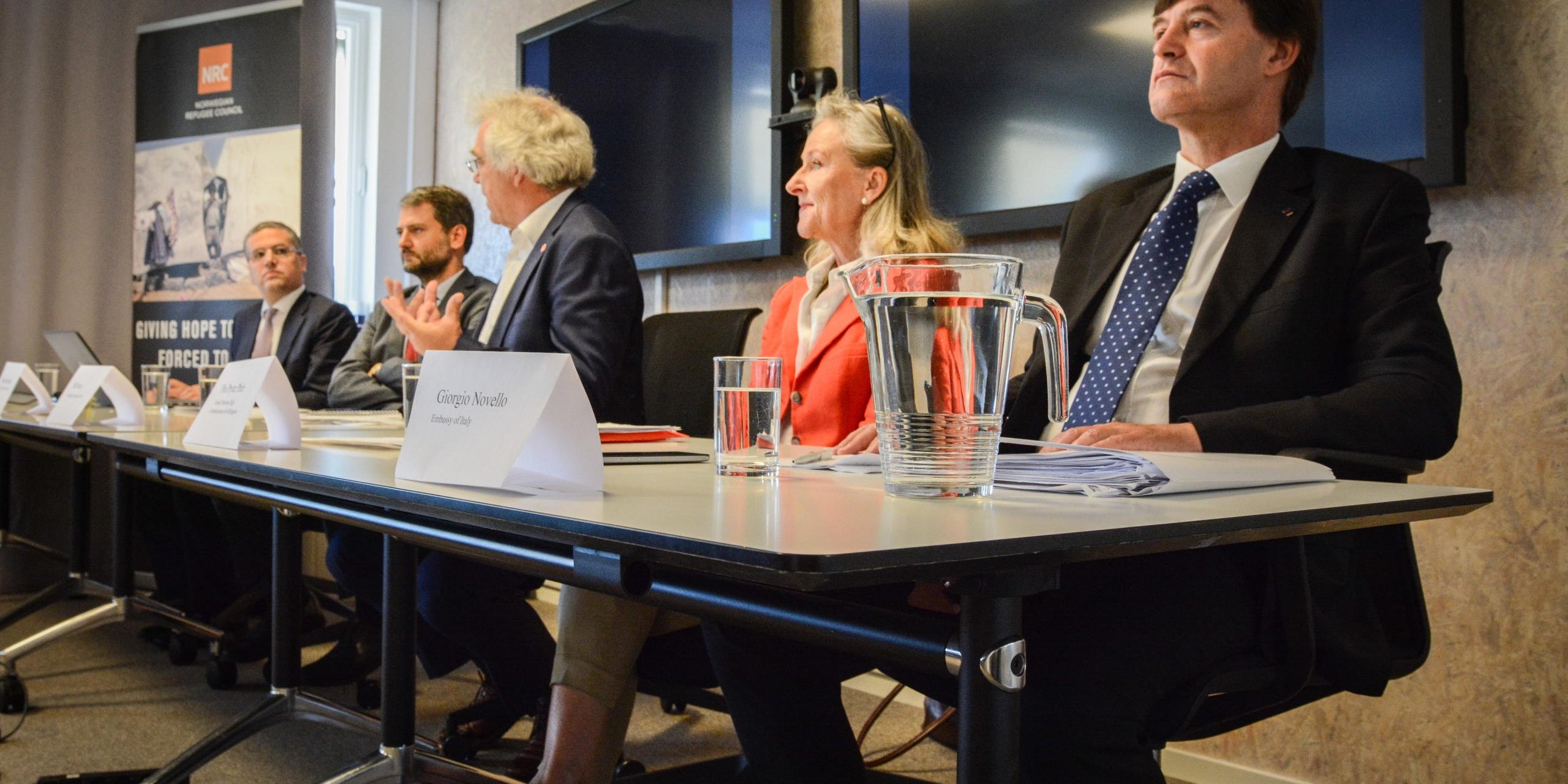 Italy´s ambassador to Norway Giorgio Novello (from the right), Regional Representative from the UN Refugee Agency (UNHCR) Pia Prytz Phiri, Senior Adviser at the Norwegian Refugee Council Pål Nesse, Head of International Relations at Sant´ Egidio Community Mauro Garofalo and moderator Tommaso Andria, deputy head of mission at the Italian embassy during the seminar ´Alternative legal paths to Europe´ Photo: Tiril Skarstein, NRC