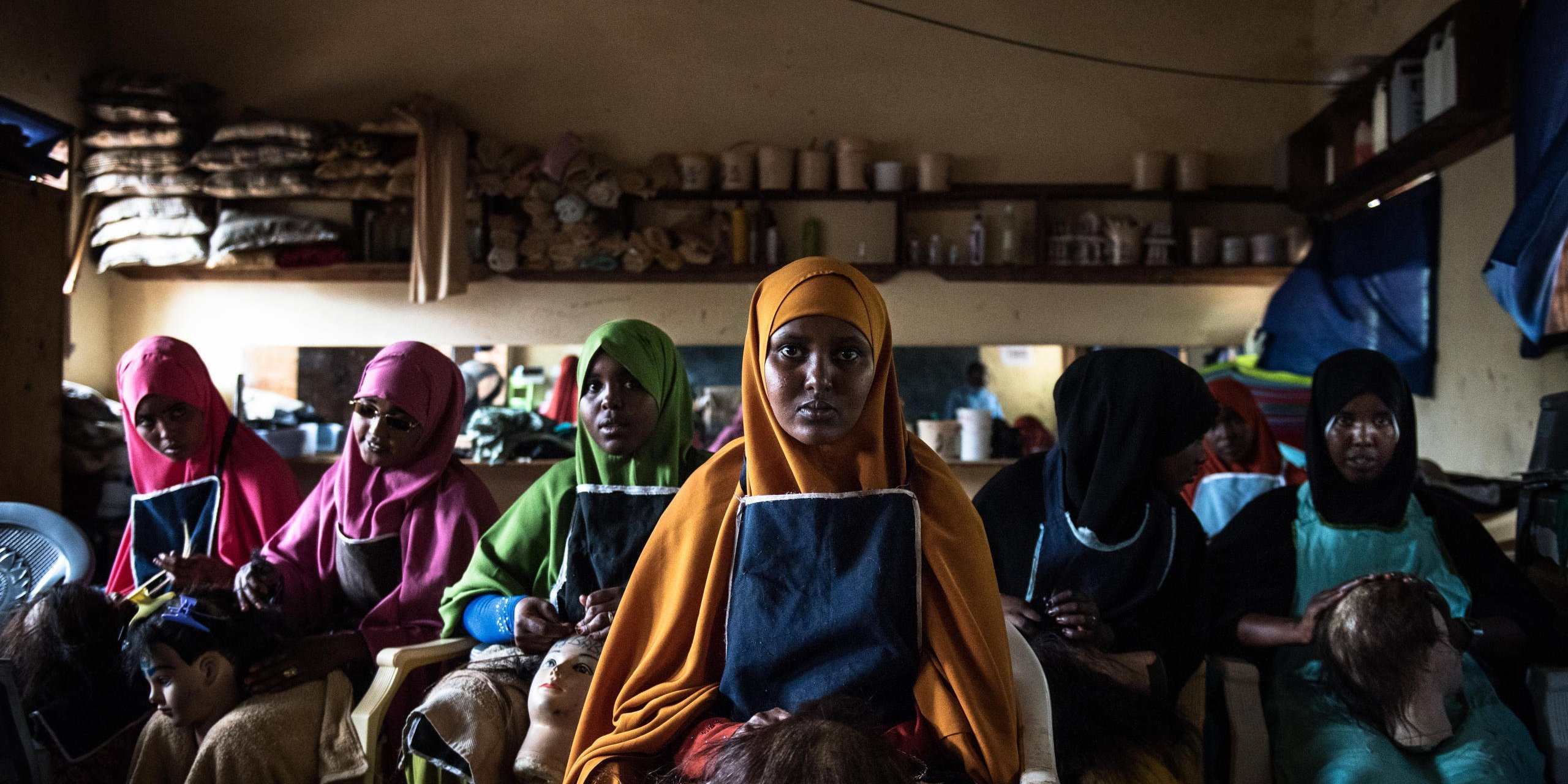 (L-R) Abdijo 18, Scadijo 18, Snado 17, Fartur 23, Ayar 20 and Fatuma 20 are training to be hairdressers at the NRC-supported youth skills centre in Dadaab, Kenya.
The beauty school is part of NRC’s youth education programme. It is a one-year informal education programme designed to support young people affected by conflict, who have a lack of opportunities or missed out on school. Through the programme, youths acquire a marketable skill to increase their chances for finding employment. It includes crafts such as tailoring, journalism, hairdressing and welding.
Date: September 2016
Photo credit: NRC/ Fredrik Lerneryd
Text: michelle.delaney@nrc.no