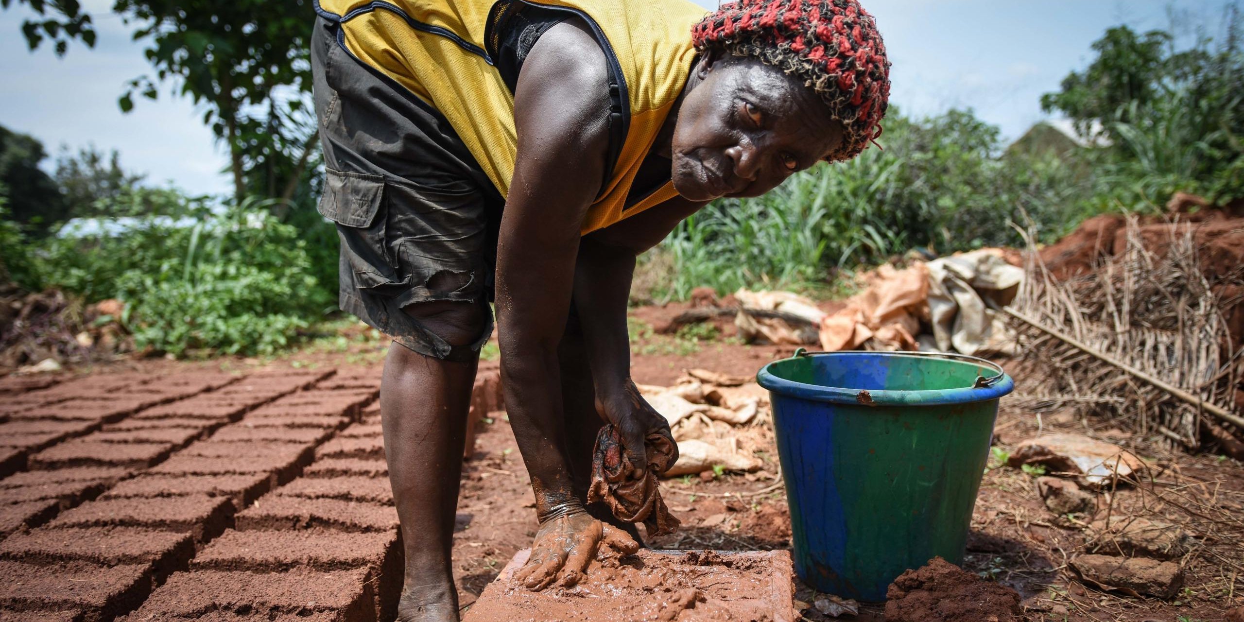 Honorine Essibeda (76) is recieving support from The Norwegian Refugee Council to rebuild her home in Begoua. Here she is helping with the bricks.