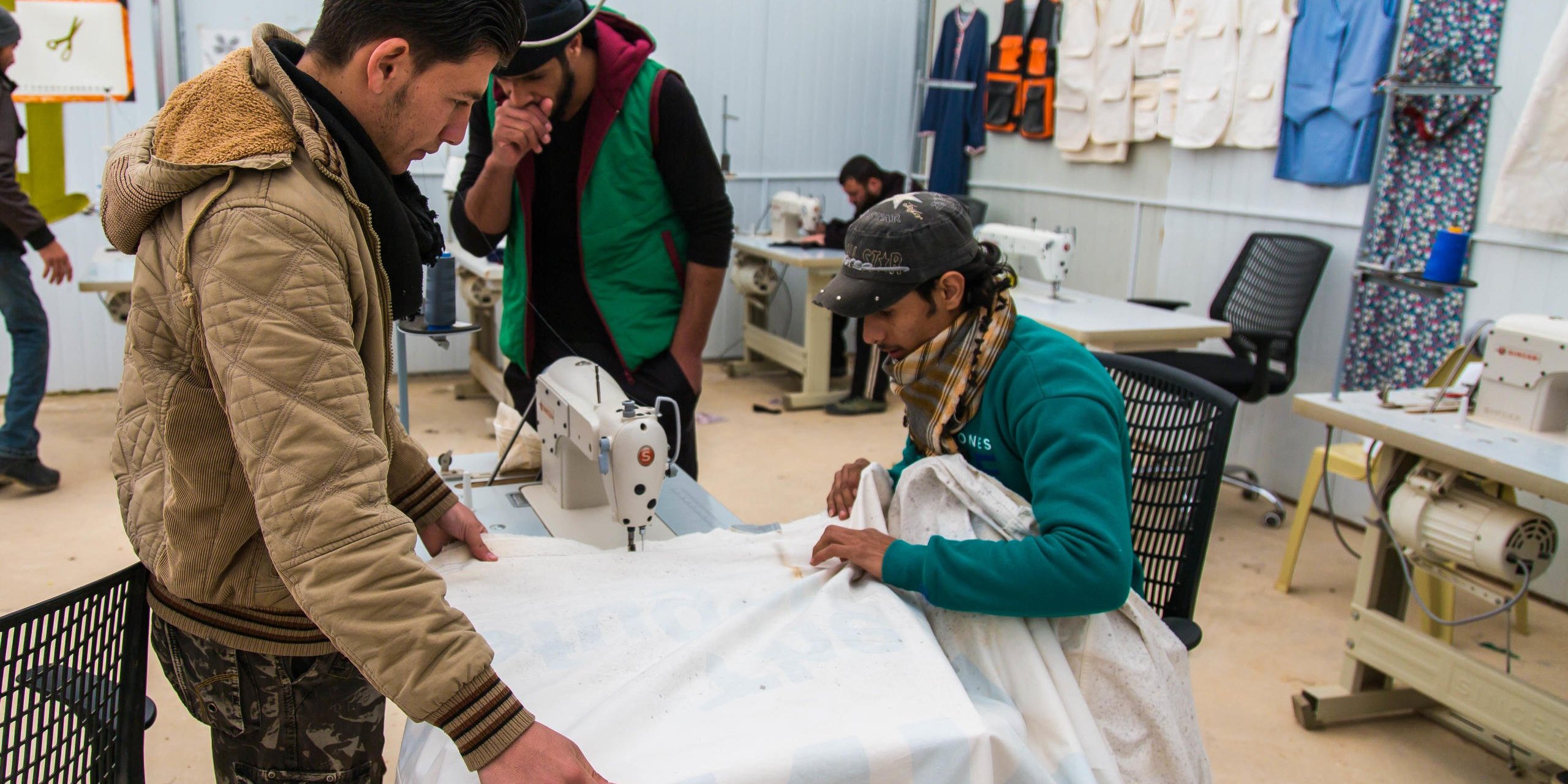 A group of Syrian refugee youth making a curtain out of a piece of recycled cloth at NRC's Youth skills training centre in Zaatari refugee camp in Jordan.

Photo: John Cutliffe/NRC
February 2 2016