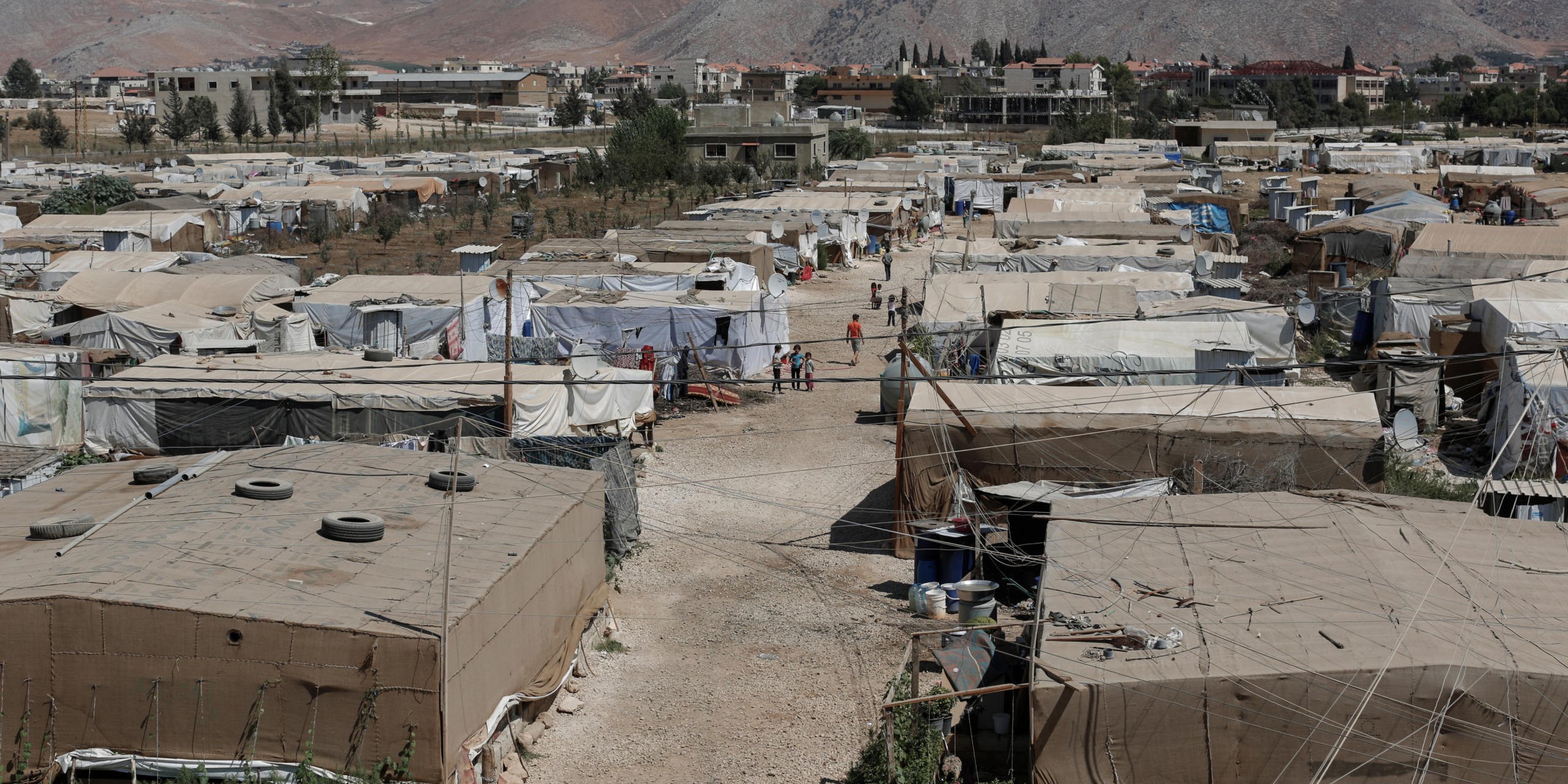 A view of a refugee settlement of the Ghazzeh informal tented settlement in Lebanon's Bekaa Valley.
The Ghazzeh ITS is one of nine currently benefiting from a pilot Community Capacity Building (CCB) project run by the Norwegian Refugee Council.
The committee, supported by NRC, has been provided with mobile phones and other materials to facilitate coordinating with service providers directly, to monitor and report the situation in their ITS, and to monitor the levels of assistance provided to them to decrease reliance on external agencies and give the refugees more control over their own situation.
CCB committees comprise around ten members, with five pairs responsible for men, women, the elderly, youths, and people with specific needs. NRC is currently working with CCBs at nine informal tented settlements and plans to expand the project to seven more in the near future.
NRC/Sam Tarling