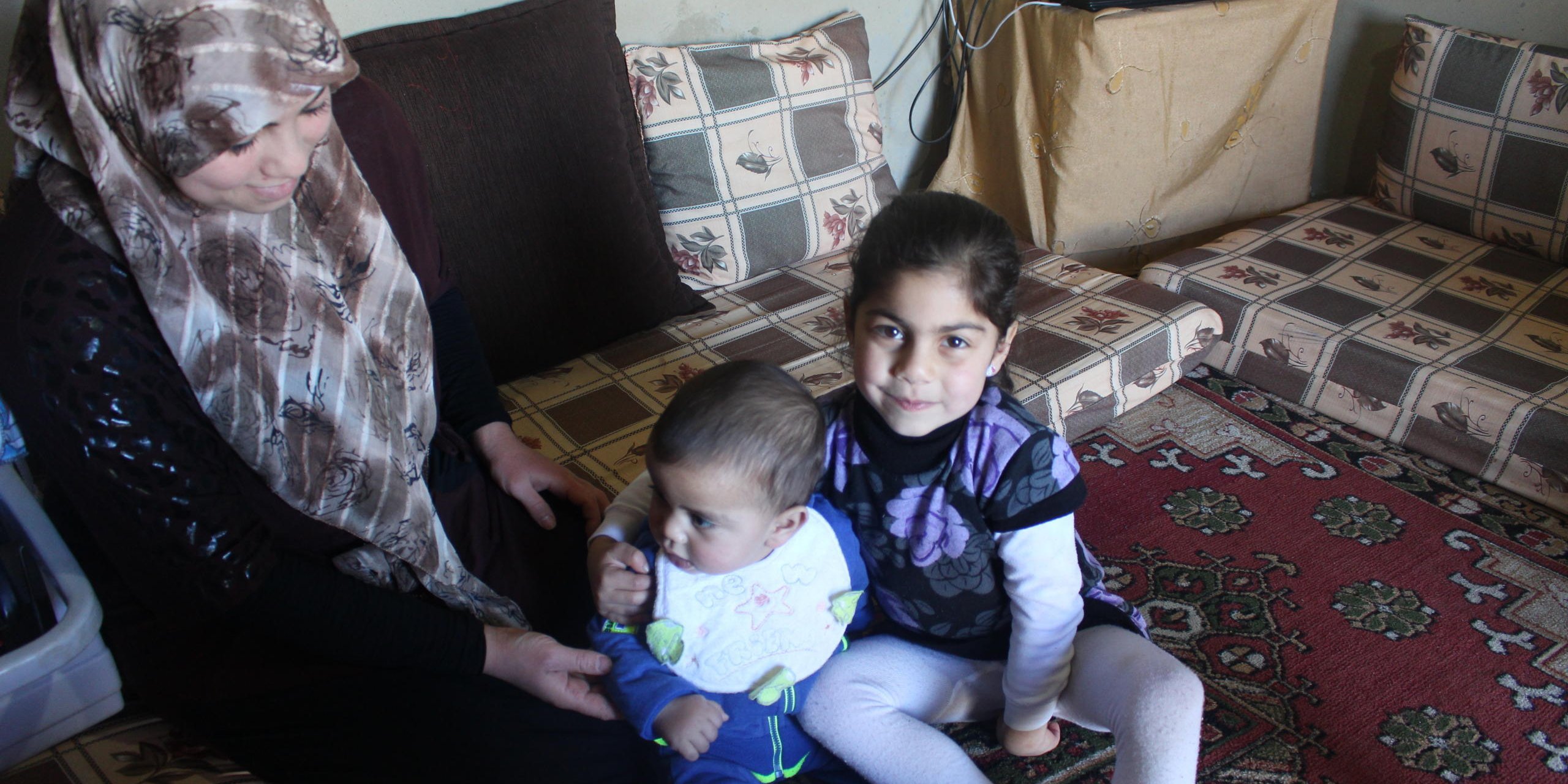 Ilham, her younger brother Youssef, 9 months old, and their mother Safa, 26, in the family's living room in South Lebanon. Youssef was born in Lebanon and his parents have not yet registered his birth, which makes him at risk of being stateless. NRC’s Information, Counselling, and Legal Assistance (ICLA) team are supporting Youssef’s parents to formally record Youssef’s birth.
Photo: NRC/Rayane Abou Jaoude