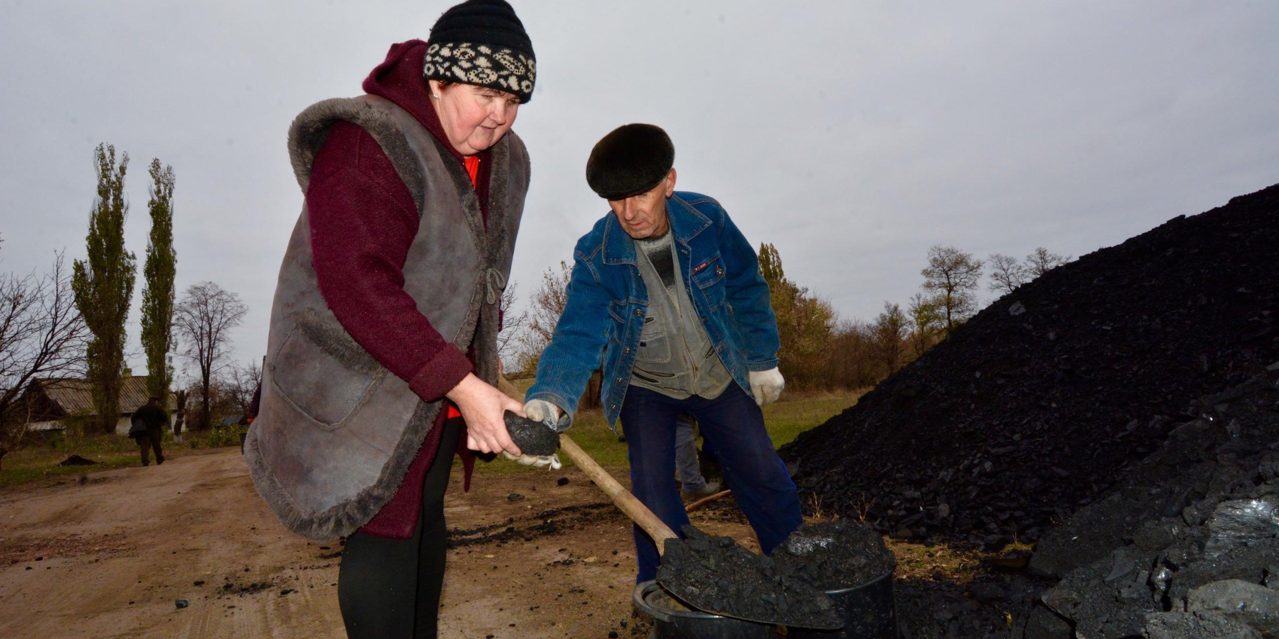 439 households living in the “grey zone” settlement Zolote 4, Popasna district received coal from NRC within “Winterization Program”.
Earlier NRC brought the 878 cubic meters of firewood for Zolote 4 residents.
Each household in Zolote 4 received 2 tons of coal and 2 cubic meters of firewood.
Rita (56), pensioner, Zolote 4, “I worked in the mine for 36 years. It was hard job. Now I am retired, but my pension is 1,400 hryvnias (53 USD), so I can hardly buy food and pay for utility services. The coal and firewood provided by the NRC will enable me to survive this winter, as it is expected be very cold”.
Rita also says that children in the village differentiate whether it is shooting or shelling, incoming or outgoing.
Her grandchildren were hiding in the basement during the shelling, where it was humid and wet. Now they have problems with lungs and very often stay in the hospital with bronchitis.
