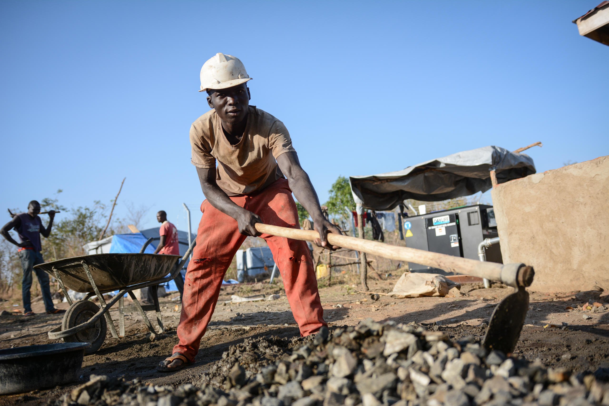 Patrik (23) from Uganda is hired as a construction worker to help build a new motorized borehole which will provide water to South Sudanese refugees and the host community in Bidibidi.
“Uganda also benefits from welcoming the refugees. Infrastructure is being developed and schools constructed to the benefit for everyone. The large influx of refugees also creates new employment opportunities, " he says.
He also believes Uganda has a responsibility to support their neighbors.
"We welcome the refugees. They had a hard life in South Sudan and escaped to save their lives, so we need to be there for them. Uganda has a reputation for helping refugees and a long history of doing so, but we also need support from other countries," he adds.
Photo: NRC/Tiril Skarstein