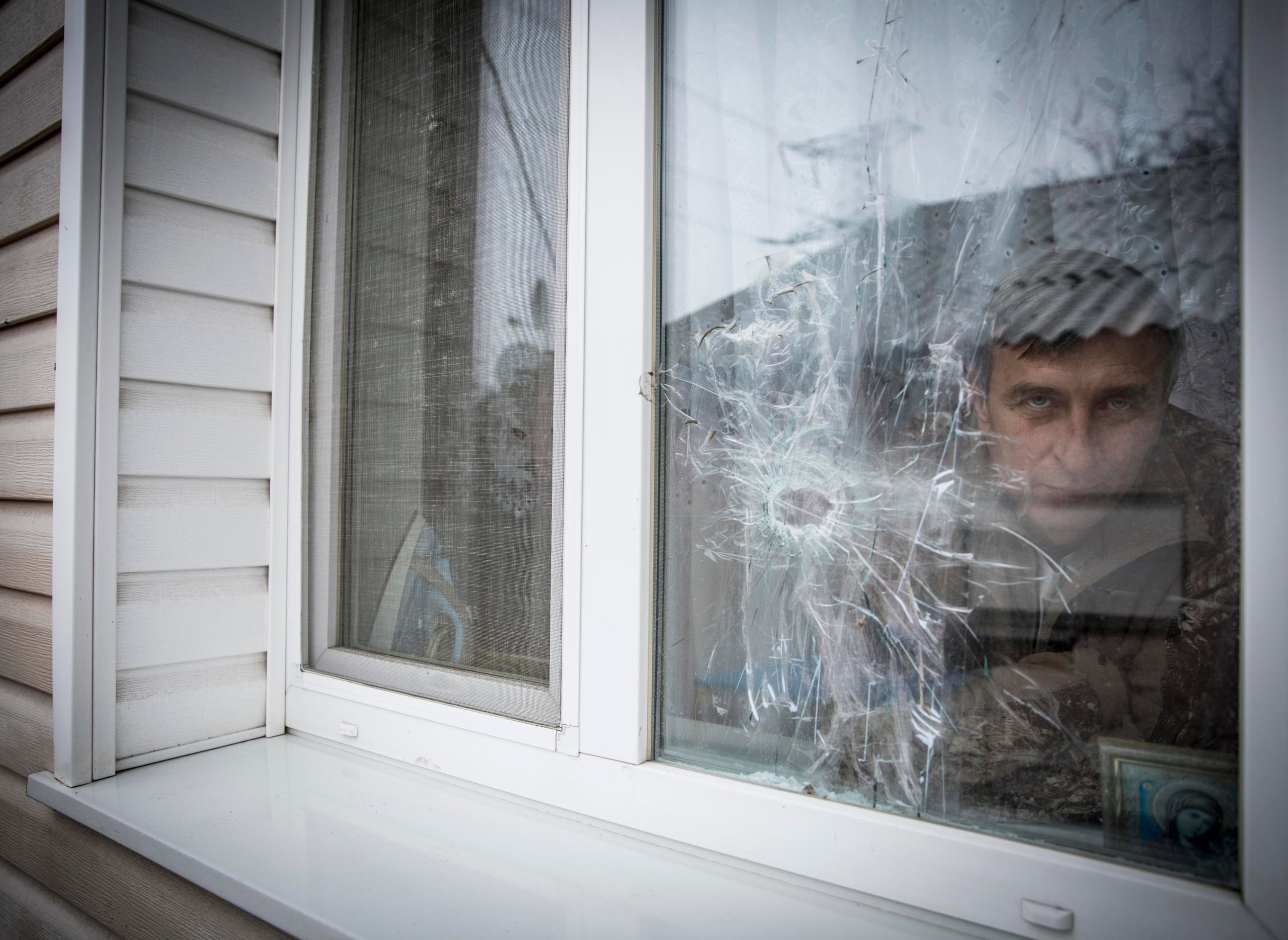 “I missed my home”. Yurii Polieshko returned to his village by the contact line after some time in Russia despite damages to his house, loss of income and frequent shelling. 

Liudmyla, 51 and Yurii Poleshko, 55, lives in the frontline village Zaitseve in Donetsk region. For the last three years they have been unable to find jobs and survive only owing to humanitarian assistance and relatives’ support. 

“We used to have levelled life. We did our own business. My wife owned a hairdressing salon, I was the owner of ventilation system control enterprise in nearby Horlivka (currently non-government controlled area). We were providing our services in several regions – from Luhansk to Zaporizhzhia in eastern Ukraine. However, the conflict, which came to our country in 2014, turned our life upside down. Initially, when the hostilities started, we tried to continue our work, but when the crossing point was set up in our village, we were urged to shut down all our business, because of limited access to that area. It was in August 2014. ”, - says Yurii Poleshko. 

Since the conflict outbreak, Zaitseve has become one of the hot spots of crossfire between conflicting parties. One part of the village is under Ukrainian Government control, another under de-facto authorities.  Despite the ceasefire agreement, the hostilities are still ongoing., Usually the shelling starts there, when it gets dark, sometimes the incidents happen in the daytime. At the streets you can hardly find its residents, people try not to come out unless it is absolutely necessary. Most of the windows in the houses are closed with plywood, firewood and shields. People use all possible means to protect themselves. Many residents left the settlement, mostly the elderly people remained. 

 “We felt abandoned. For a while it was no man’s land. In 2014 it was even difficult to bury someone in the settlement, because administratively the settlement was subordinating to non-government-controlled Horlivka”, recalls Yurii. 

“Initially we left the settlement in December 2014 after very heavy shelling, the whole night we were sitting in the basement. It was too stressful for us. For 8 months we were staying with relatives and friends.  Our friend even proposed to buy a house for us in Russia, but we refused, because there is nothing like home”, - says Yurii. 
“We cannot explain why we returned. We are probably too attached to the house. How could we leave all this? Yes, it is scary to hide in the basement. But when you come out from it you are home”, says Liudmyla. 

In 2016 Poleshko’s house was damaged by shrapnels. They could enter the house only through the window, because the door was curved by the explosion and could not open. The family repaired the house. However, when you enter the house, you can still see the shelling traces; holes in the windows, ceilings and walls.  
“I have nine years to wait before I can receive my pension. For three years we haven’t had any income. Now we are fully dependent on humanitarian assistance and our relatives”, - says Liudmyla. 

Recently, the Poleshko family started receiving cash for foodstuff from NRC. Thus, the family will be secure with food for five months during the cold season. 

“It is better to receive cash than to get in-kind assistance, because sometimes what you need is to buy the gas bottle before you can cook the food. Some people are on diet due to health issues, so they can buy food according to their own needs. For us such assistance is crucial. We are not pensioners yet. But we are vulnerable, because we cannot find the way to earn money. Psychologically it is difficult to depend on humanitarian assistance, as we used to be self-sufficient in the past”, - says Yurii.

Photo: Ingebjørg Kårstad/Norwegian Refugee Council