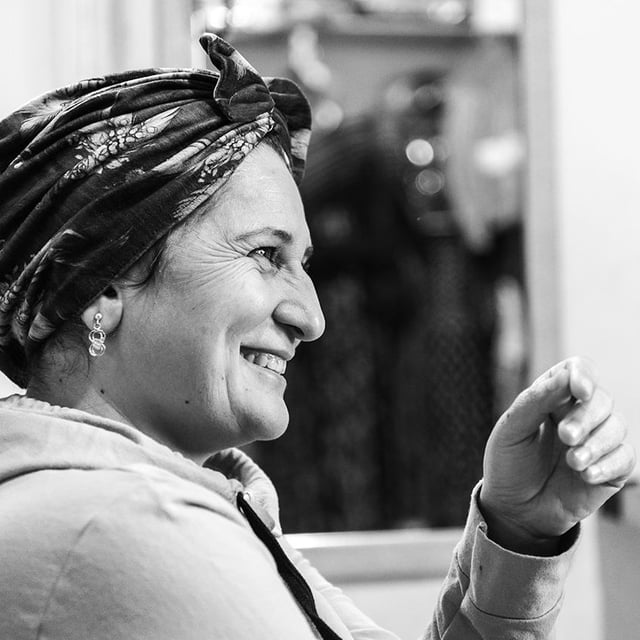 Black and white portrait of a smiling woman.