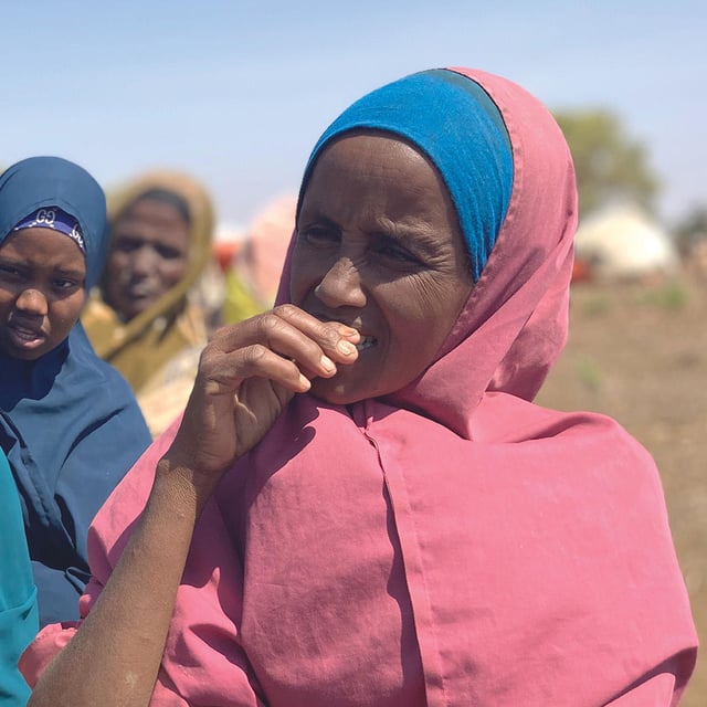Three women are standing in line.