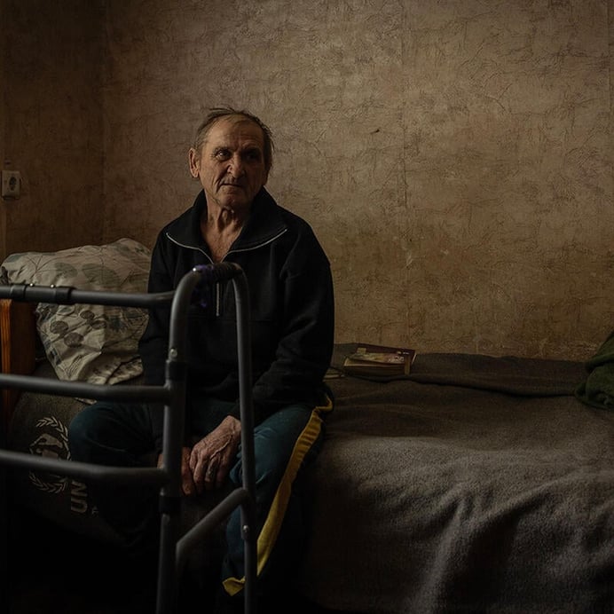 Man sitting on a bed.