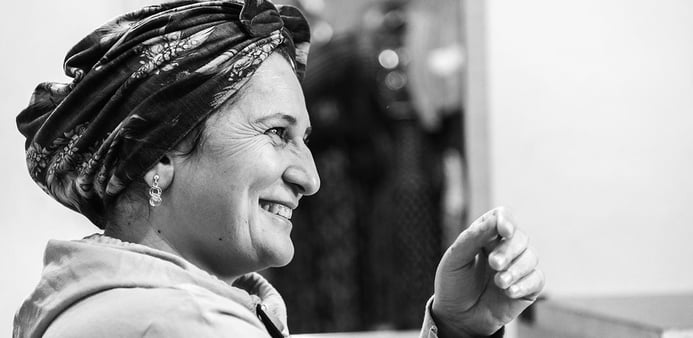 Black and white portrait of a smiling woman.