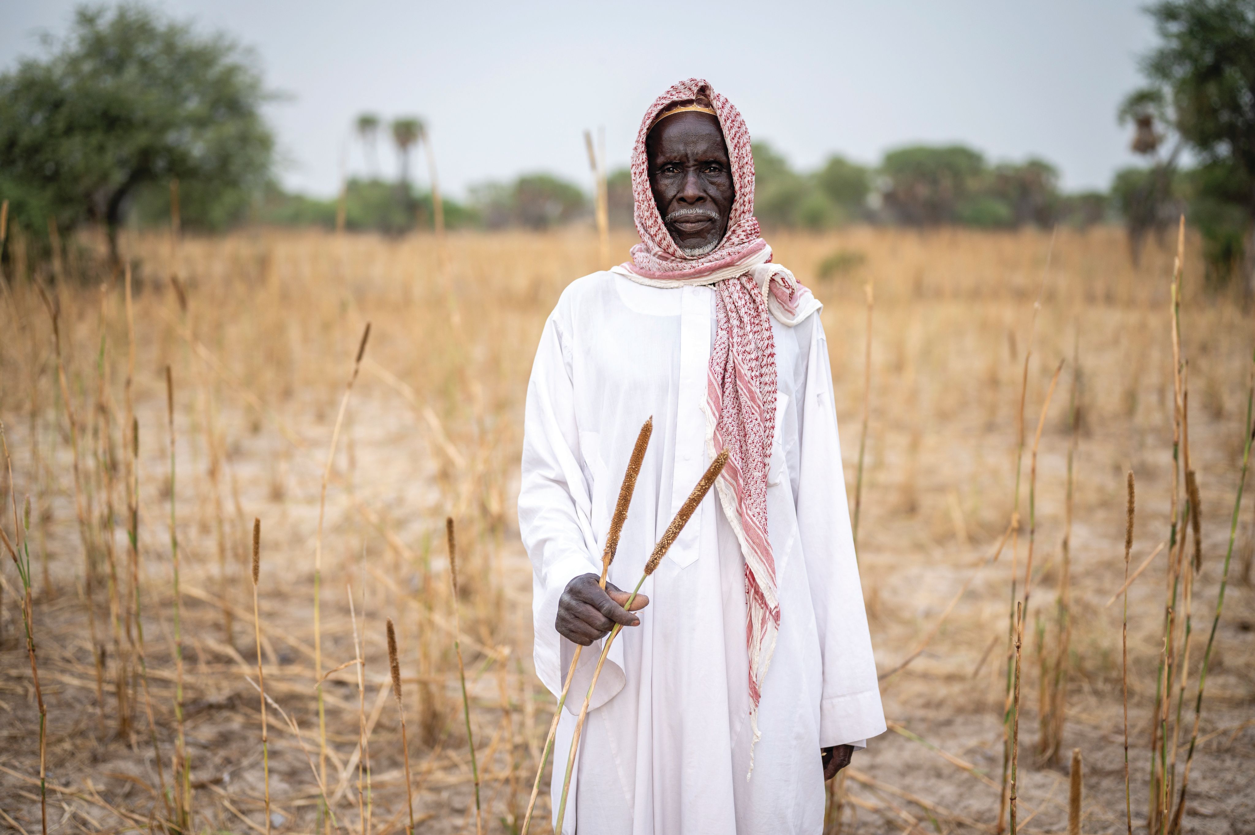 Man standing in a dry field.