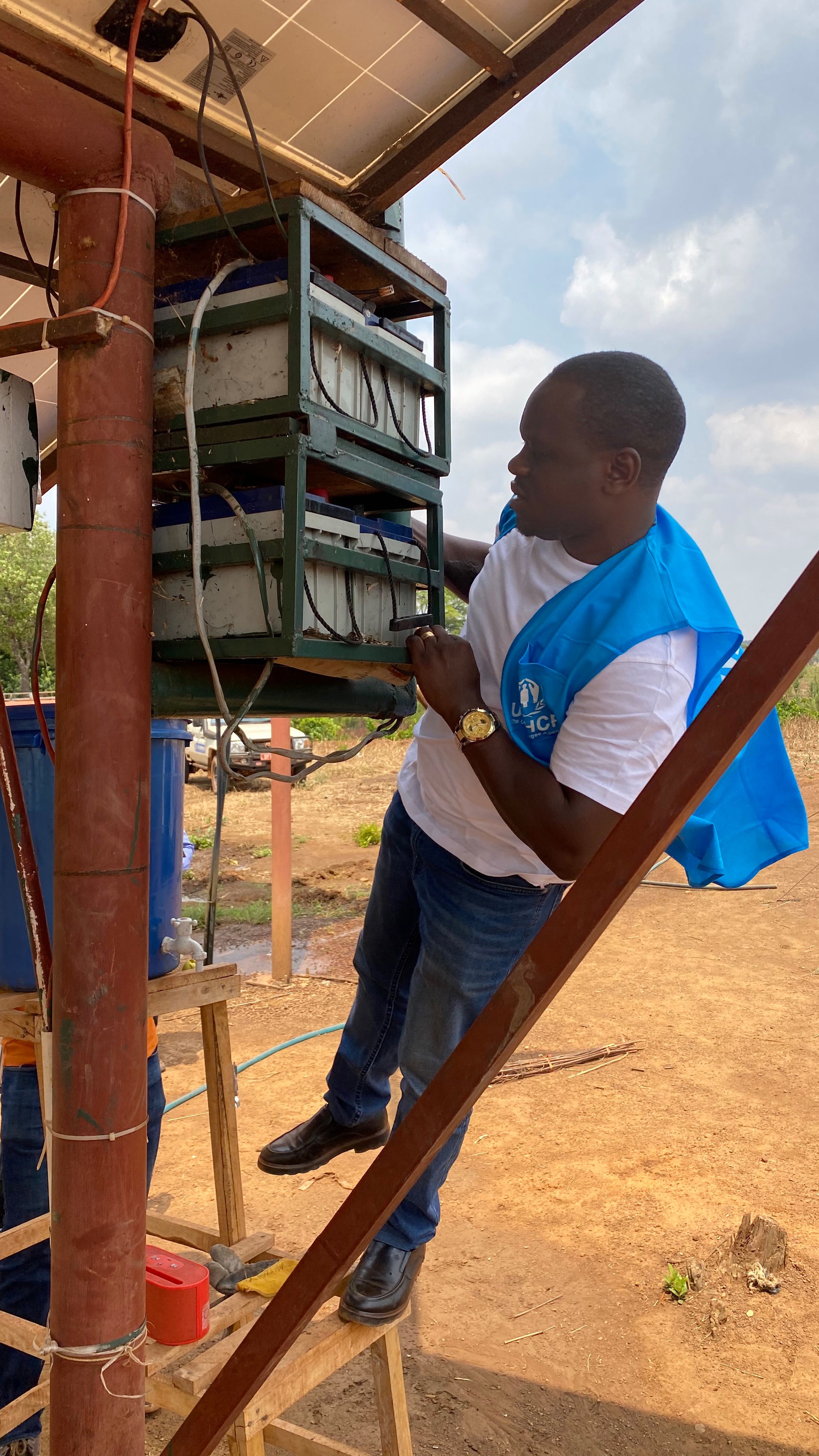 Energy expert Emmanuel Biririza inspecting the solar-powered pilot irrigation scheme in Nyarugusu refugee camp in Tanzania.