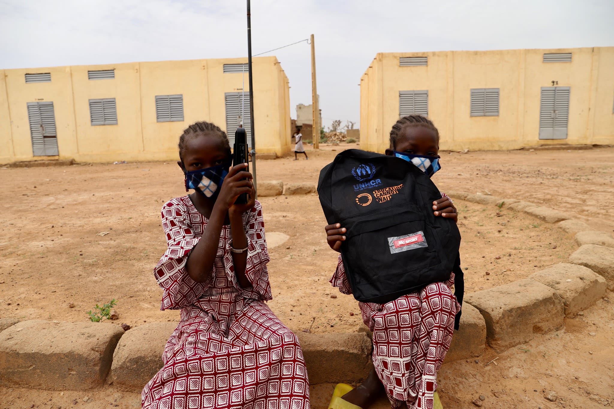 Internally displaced girls using their solar radio upon distribution in Mopti, Mali.