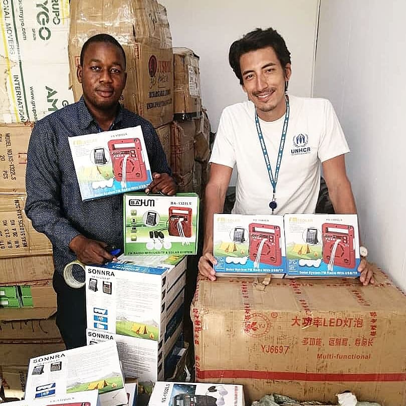 Education expert Leandro Salazar-Liévano (right) with a colleague with newly received radios, ready to be distributed to displaced school children