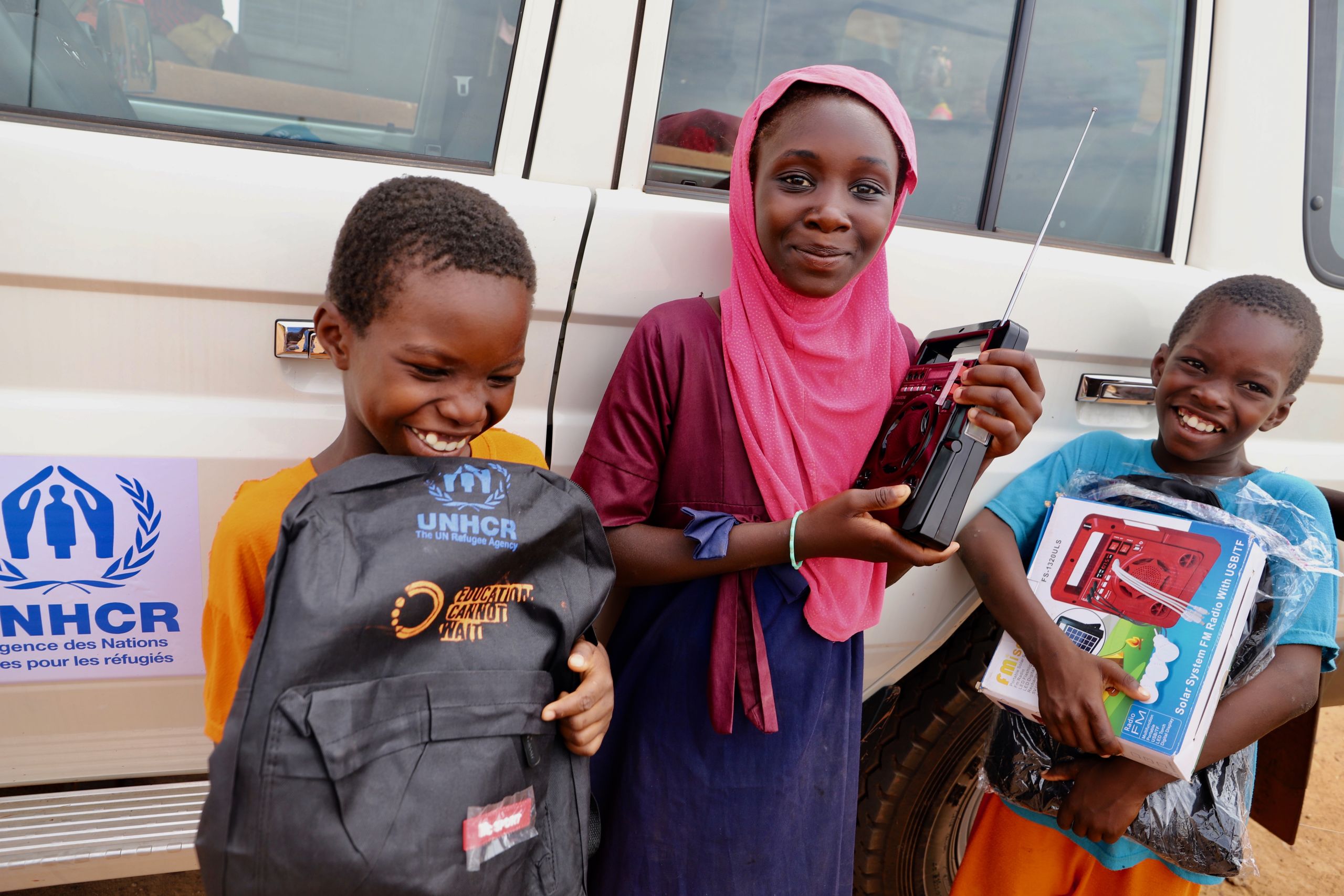 Two happy girls with their new radios and backpacks.