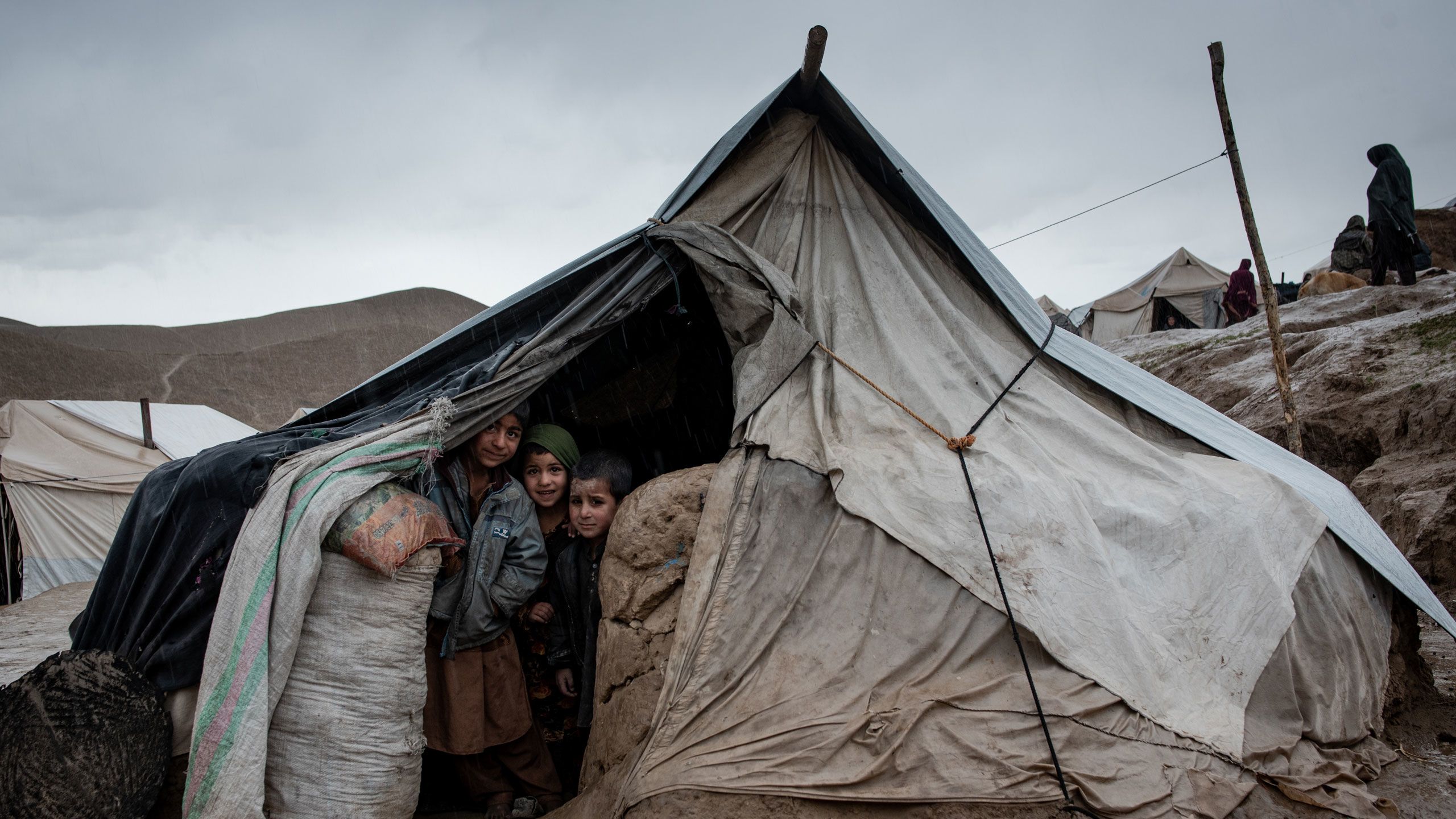 Children peer out of their tent in the Zaimati settlement for internally displaced people in Qala-e Naw, Badghis province, Afghanistan.