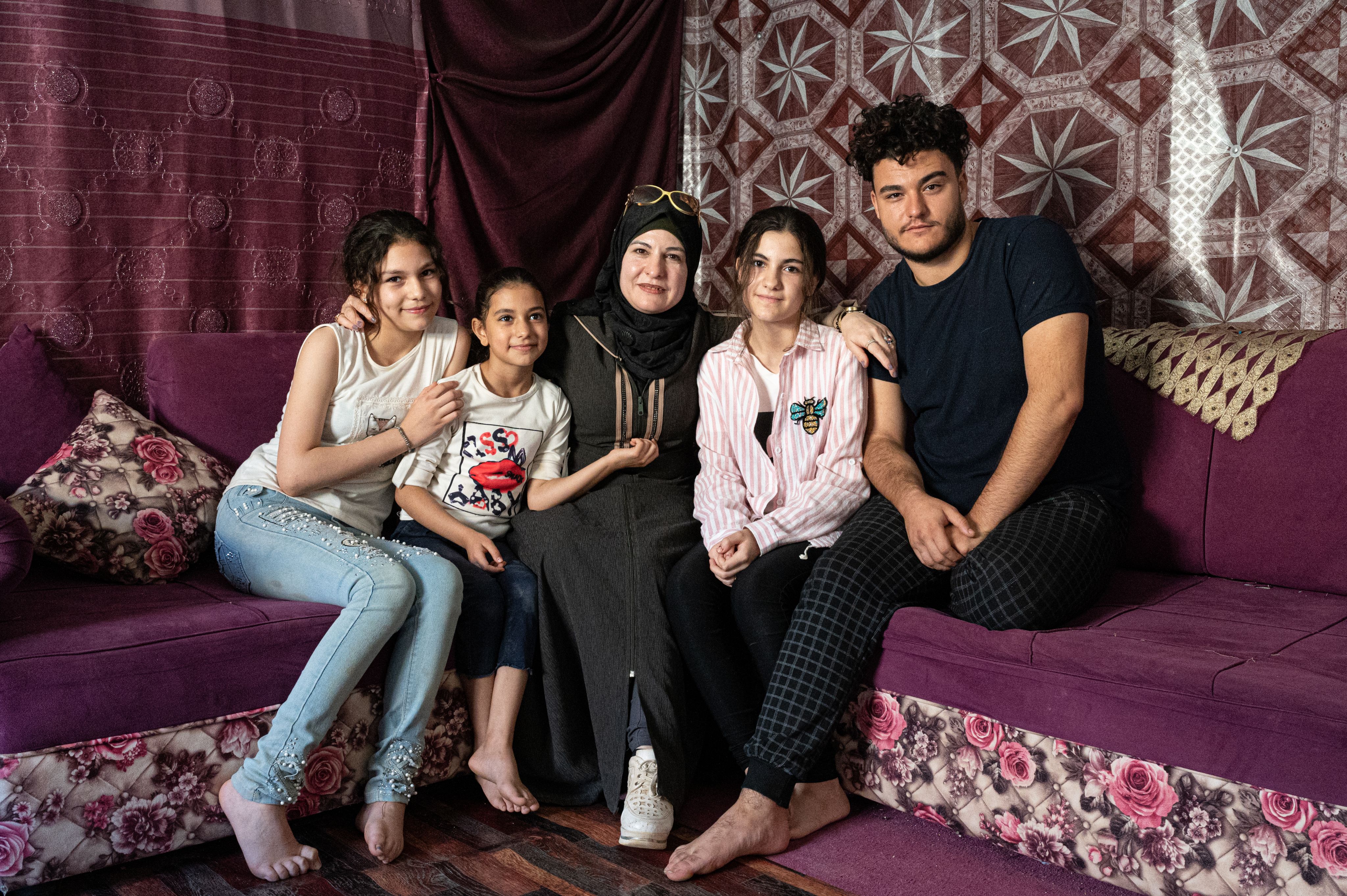 A Syrian refugee family poses for the camera