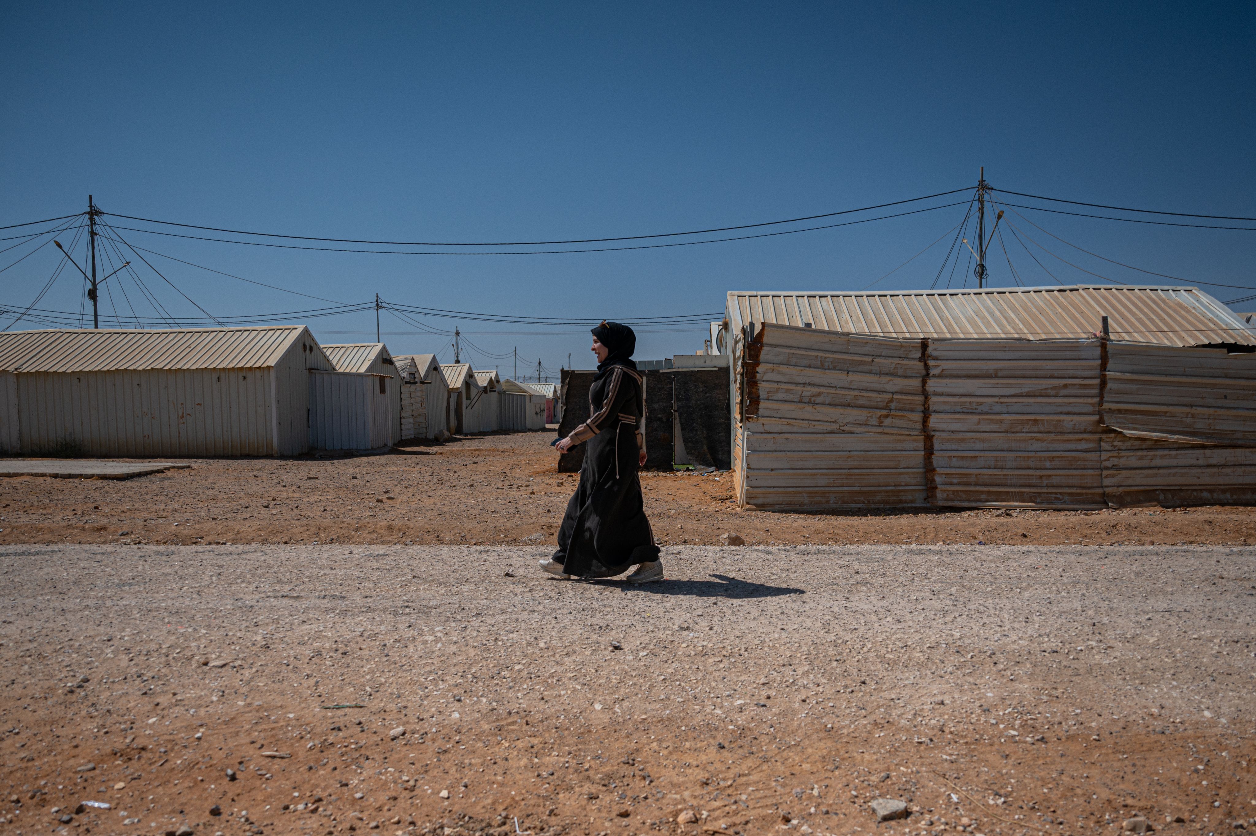 A Syrian woman walks through Azraq Refugee Camp in Jordan