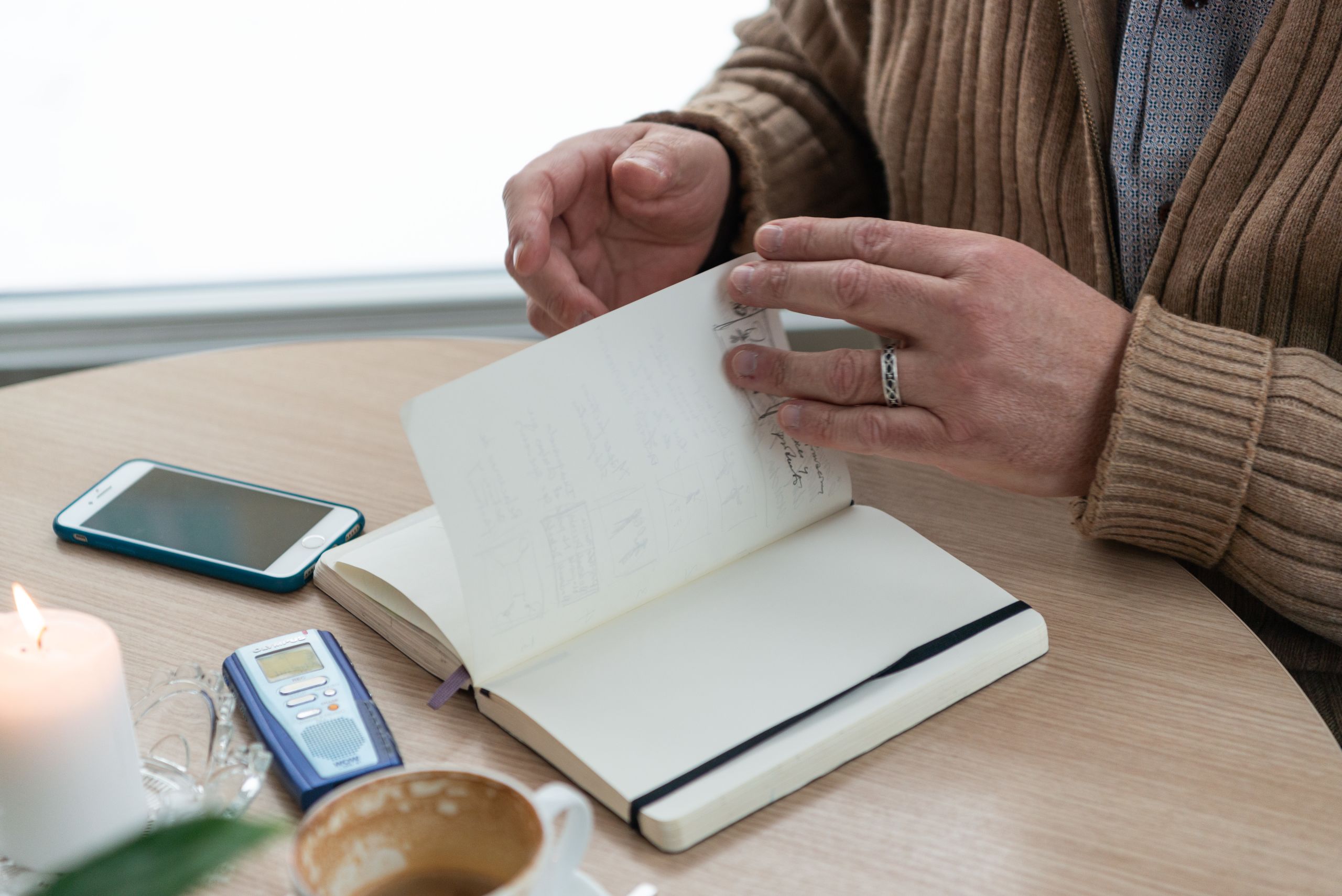 Alfredo showing the notebook in which he writes his thoughts and ideas.