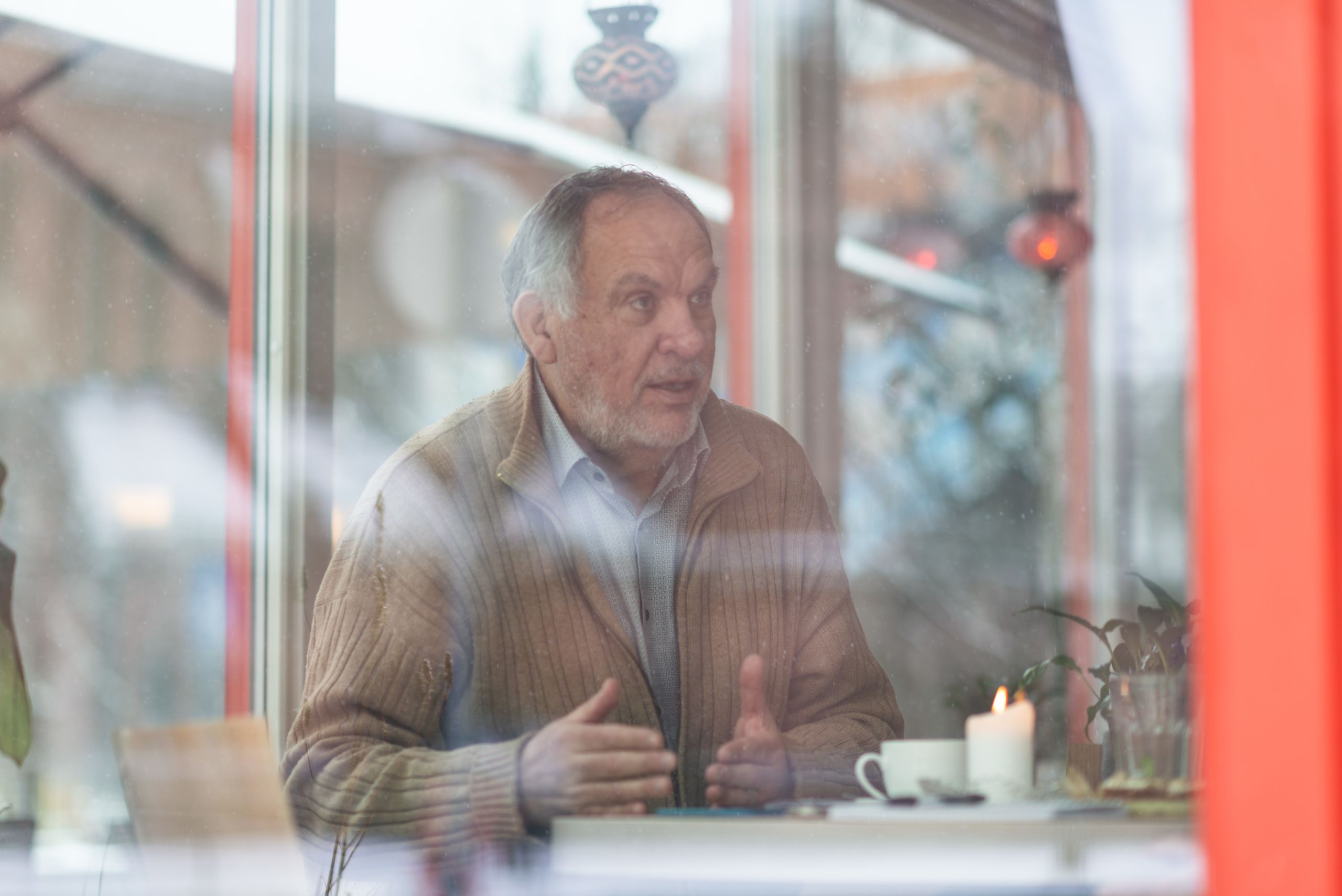 Portrait of Alfredo through a window.