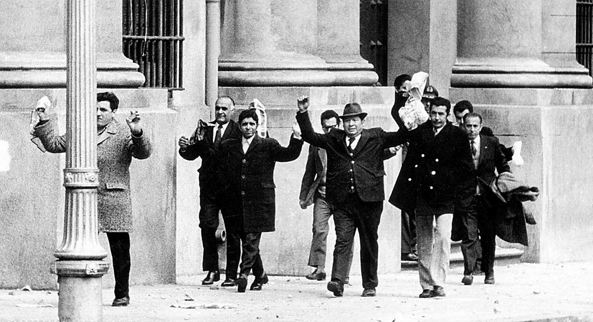 Employees leave the Chilean presidential palace after surrendering to the military during the coup of 1973.