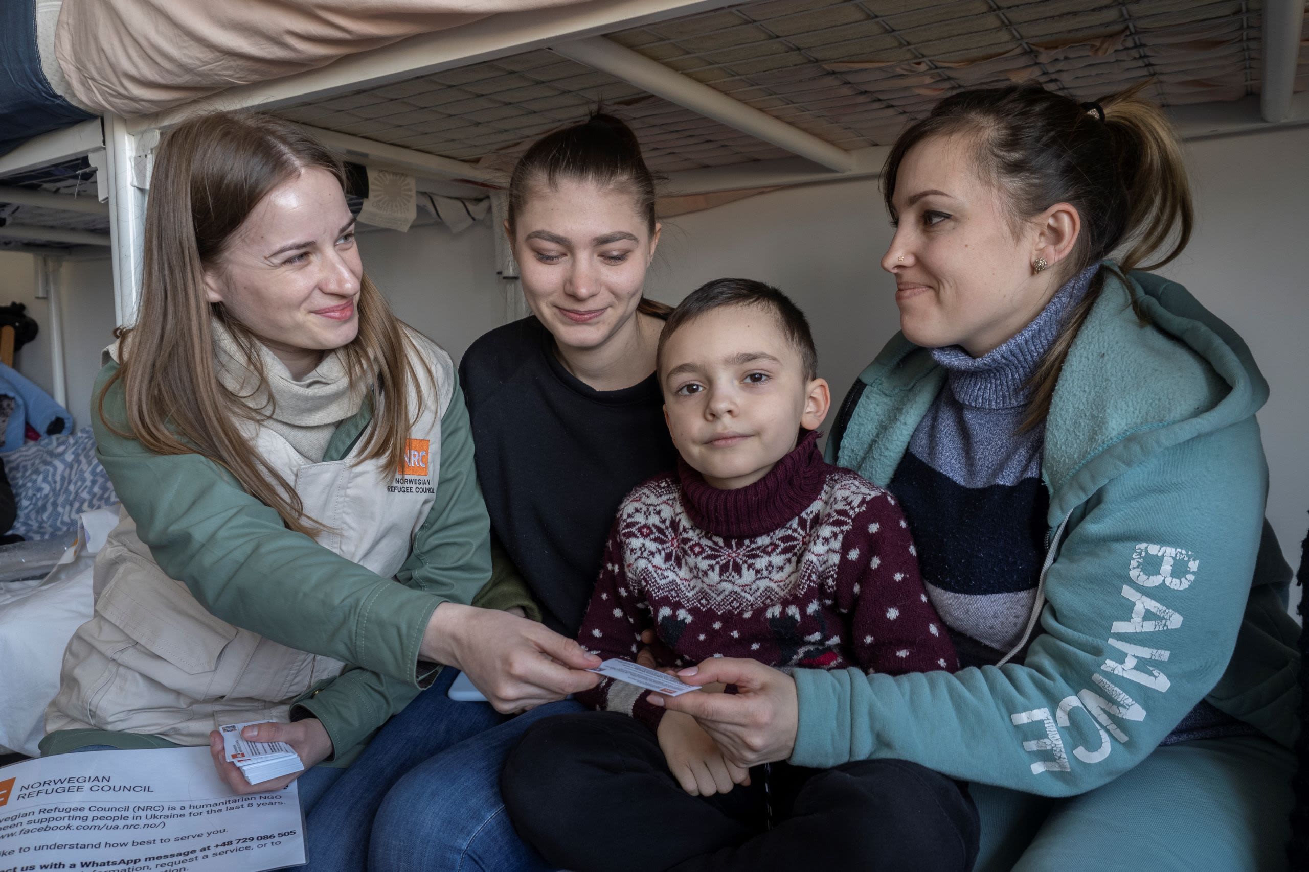 Woman talking to a family. 