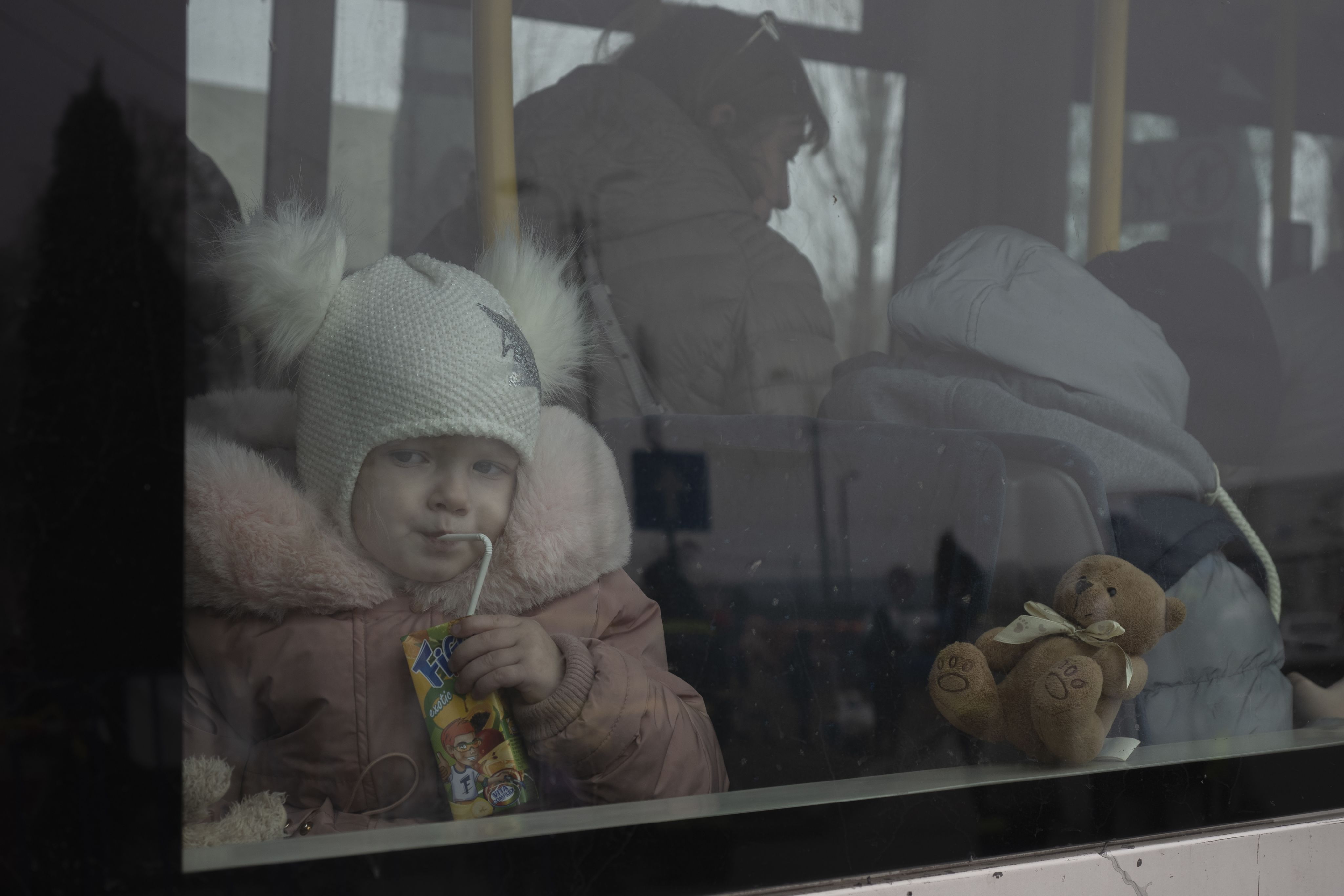 A child drinking a juice box.