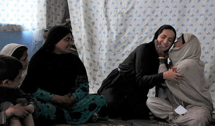 Two women hugging.
